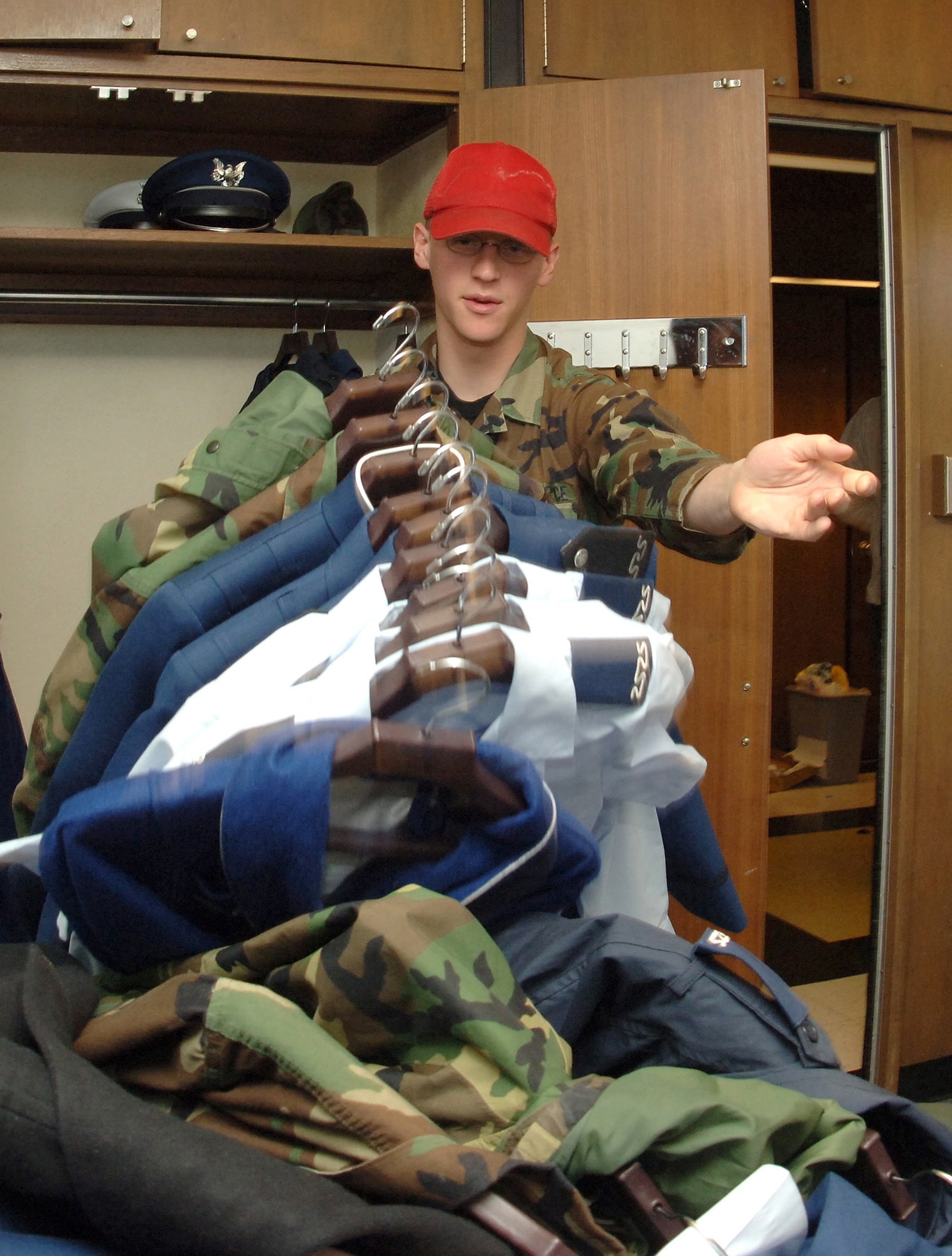 Cadet 1st Class Andrew Havko dumps the contents of a fourthclassmen's closet Saturday, March 18, 2006, at the U.S. Air Force Academy, Colo. The inspection, where upperclassmen leave fourth class cadets rooms in disarray, is a tradition during recognition. (U.S. Air Force photo/Joel Strayer) 