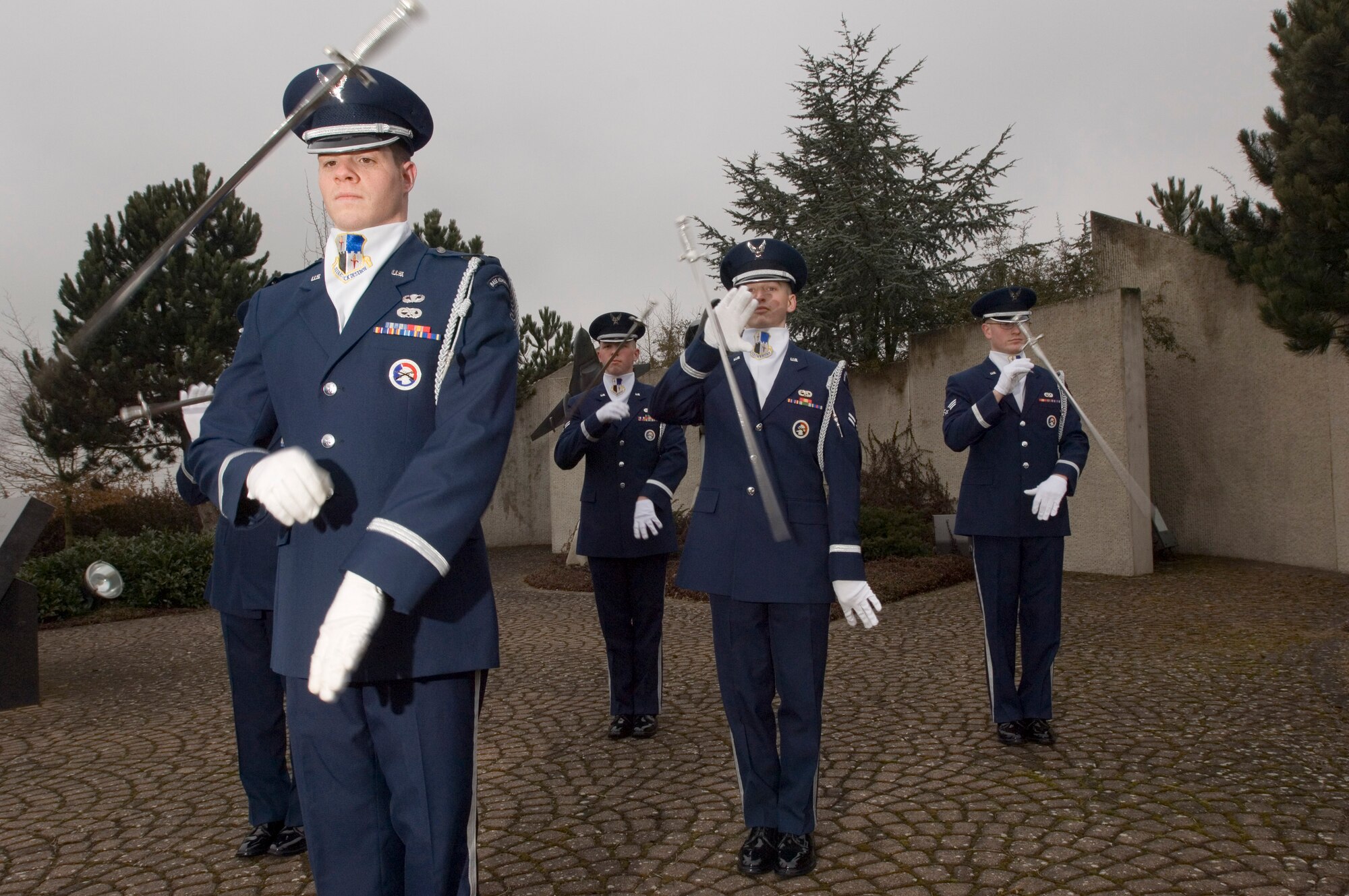 First Lt. Brian Cooper practices with fellow Eifel Sabre Drill Team members, left to right, Airmen 1st Class Jacob McCarty and Dallas Smith and Senior Airman Josh Van Derbeck at Spangdahlem Air Base, Germany, on Tuesday, March 21, 2006. Lieutenant Cooper is a maintenance flight commander for the 52nd Equipment Maintenance Squadron. Airman McCarty is a quality assurance evaluator with the 52nd Civil Engineer Squadron. Airman Smith is a computer networking cryptographic switching system journeyman with the 606th Air Control Squadron. Airman Van Derbeck is an avionics specialist with the 22nd Aircraft Maintenance Unit. (U.S. Air Force photo/Master Sgt. John E. Lasky) 

