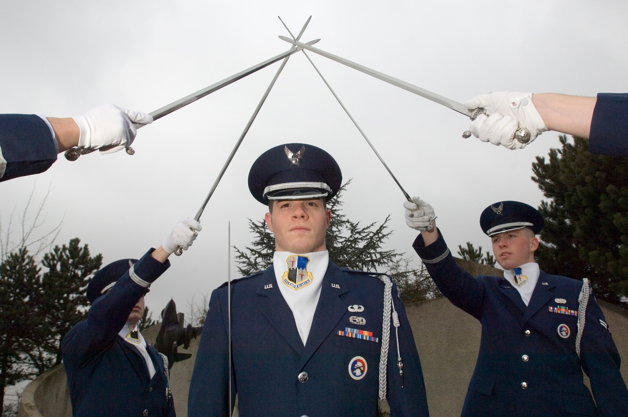 First Lt. Brian Cooper practices with fellow Eifel Sabre Drill Team members Airmen 1st Class Dallas Smith and Jacob McCarty, left and right, respectively, at Spangdahlem Air Base, Germany, on Tuesday, March 21, 2006. Lieutenant Cooper is a maintenance flight commander for the 52nd Equipment Maintenance Squadron. Airman Smith is a computer networking cryptographic switching system journeyman with the 606th Air Control Squadron. Airman McCarty is a quality assurance evaluator with the 52nd Civil Engineer Squadron. (U.S. Air Force photo/Master Sgt. John E. Lasky) 