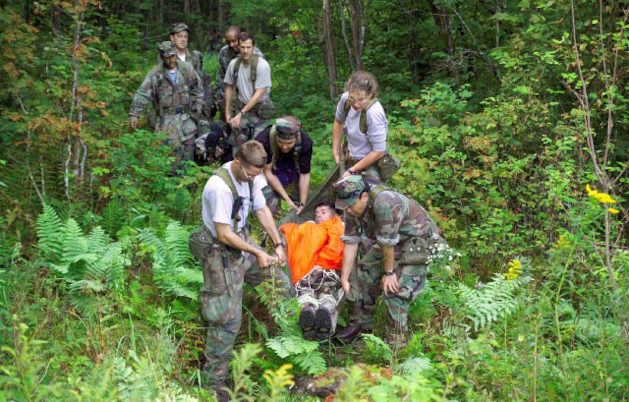 NASA's newest class of astronauts conducts an emergency egress drill during 2004 ASCAN land survival training in the wilderness near Brunswick, Maine. In the foreground, left to right, astronaut candidates James Dutton Jr., Akihiko Hoshide, Dorothy Metcalf-Lindenburger and Satoshi Furukawa use a makeshift gurney to extract fellow astronaut candidate Robert Kimbrough from the woods. In the back, Joseph Acaba, Richard Arnold II, Robert Satcher Jr. and Thomas Marshburn carry Christopher Cassidy. Hoshide and Furukawa represent the Japan Aerospace Exploration Agency. (NASA courtesy image) 