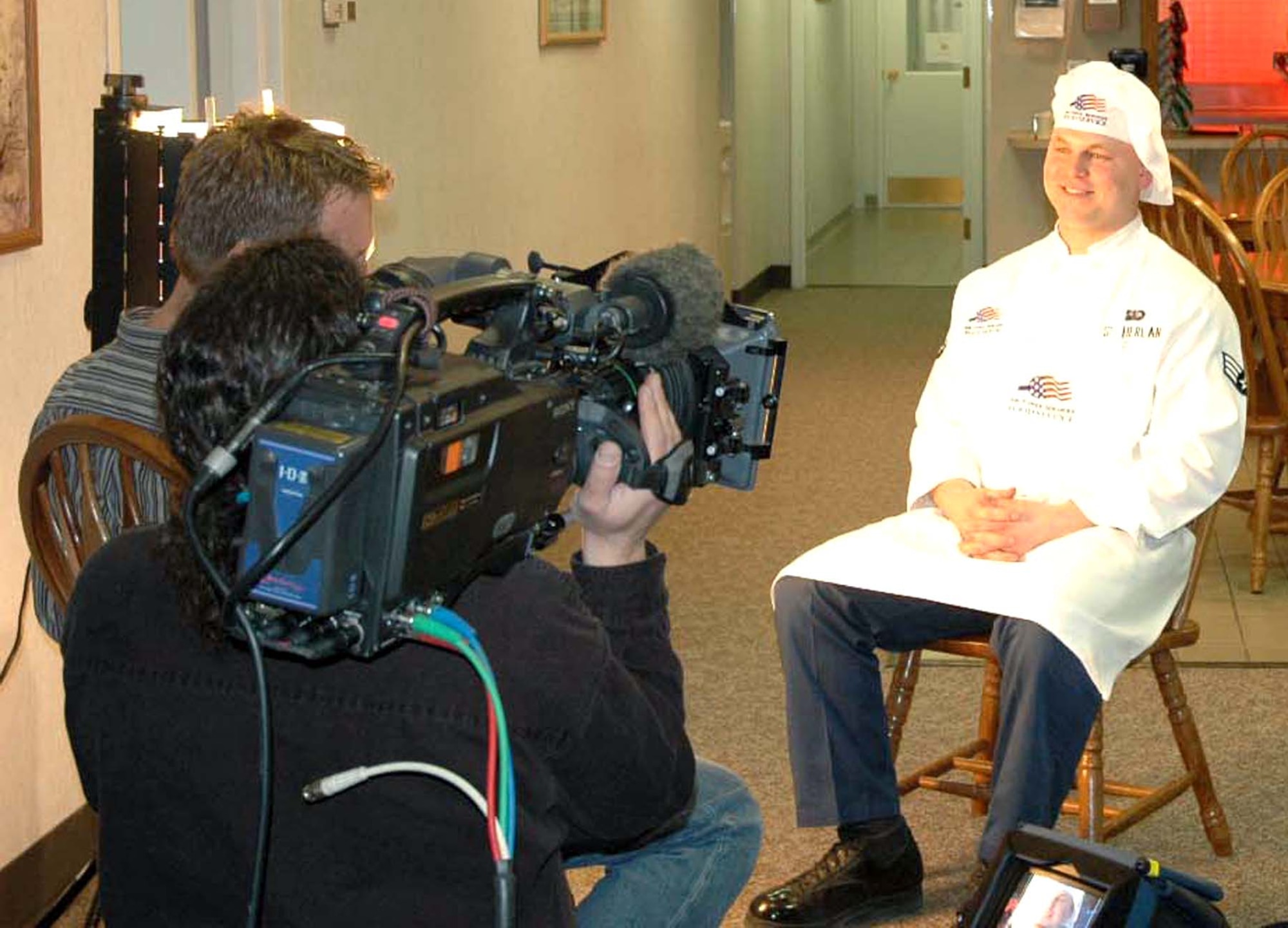 Senior Airman David Sutherland interviews with producer Dean Pedersen and cameraman Gary Feblowitz at I-01 missile alert facility Wednesday, March 15, 2006, as part of  a profile for the Food Network Challenge series.  The Airman competed against four others in the network's cookie challenge March 20 in Denver.  Airman Sutherland is a missile chef with the 741st Missile Squadron, Minot Air Force Base, N.D.  (U.S. Air Force photo/Maj. Dani Johnson)