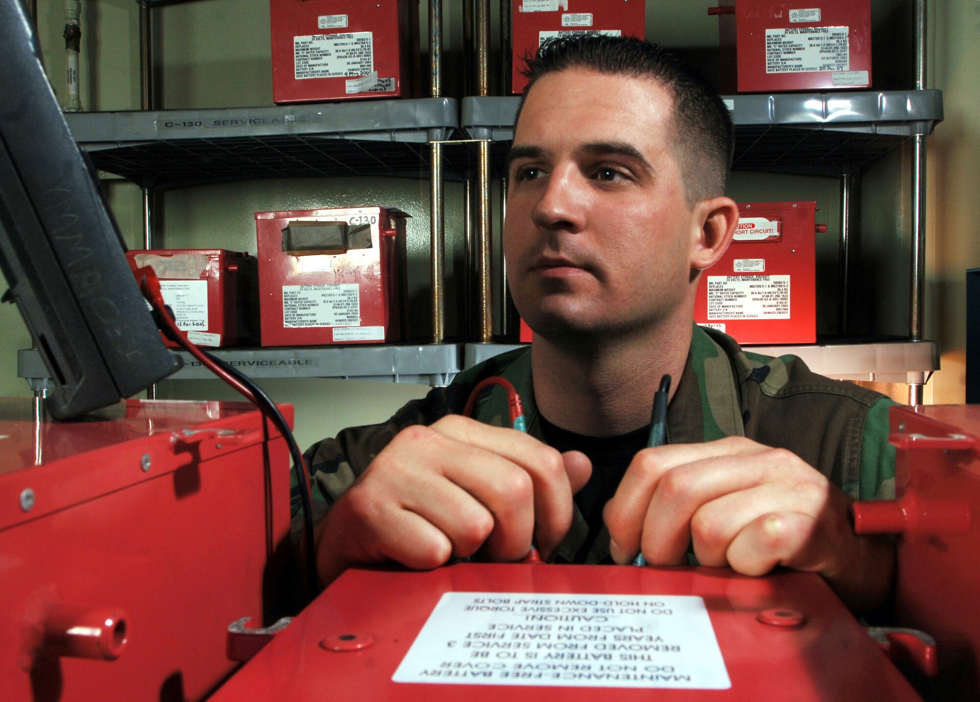 Senior Airman Josh Paul uses a multimeter to check the voltage of lead acid batteries during periodic inspection at a facility Thursday, March 23, 2006, at Yokota Air Base, Japan. The batteries are used to provide power to C-130 Hercules aircraft and UH-1 Huey helicopters here. Airman Paul is an electro and environmental technician with the 374th Maintenance Squadron. (U.S. Air Force photo/Master Sgt. Val Gempis)