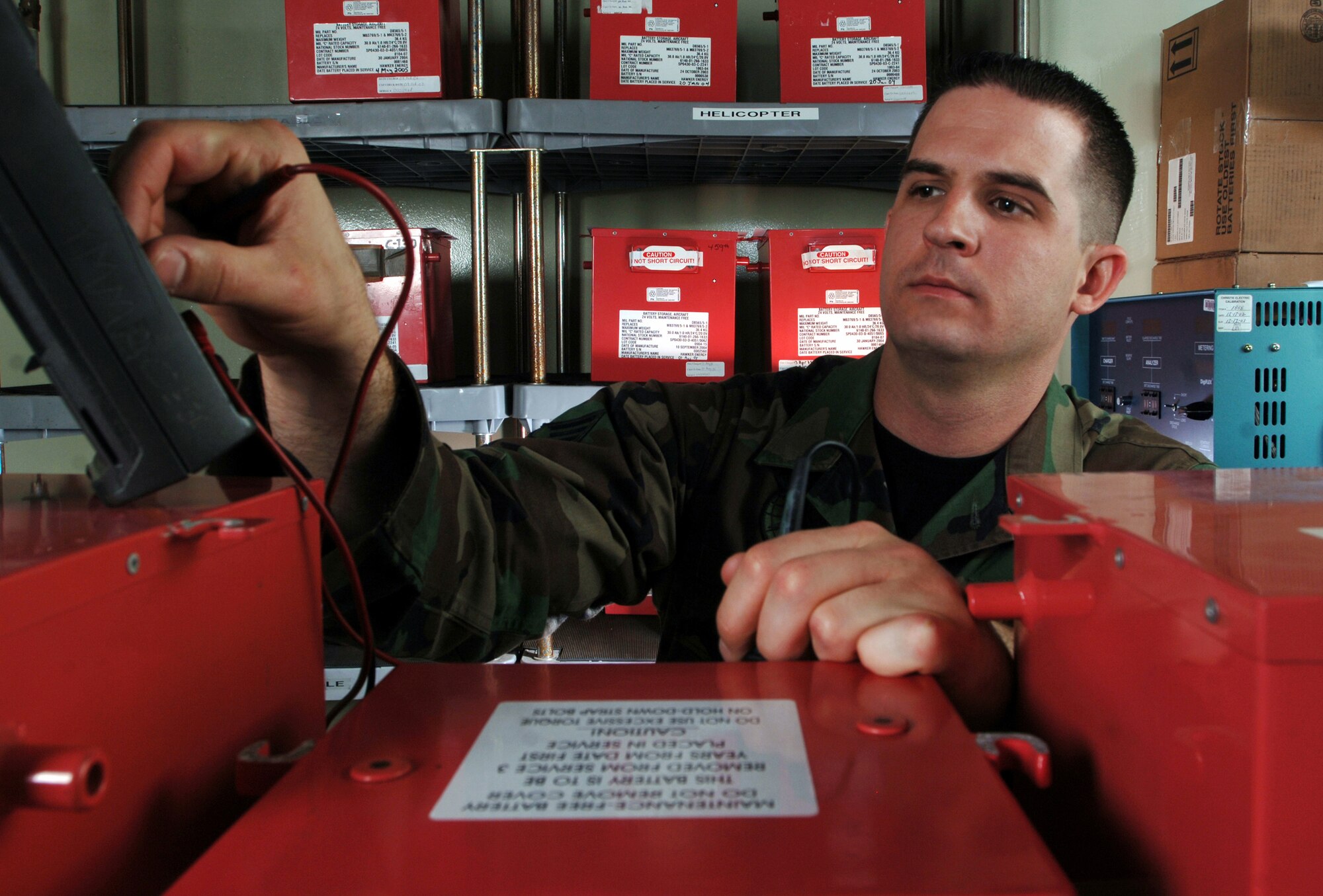 Senior Airman Josh Paul uses a multimeter to check the voltage of lead acid batteries during periodic inspection at a facility Thursday, March 23, 2006, at Yokota Air Base, Japan. The batteries are used to provide power to C-130 Hercules aircraft and UH-1 Huey helicopters here. Airman Paul is an electro and environmental technician with the 374th Maintenance Squadron. (U.S. Air Force photo/Master Sgt. Val Gempis)
