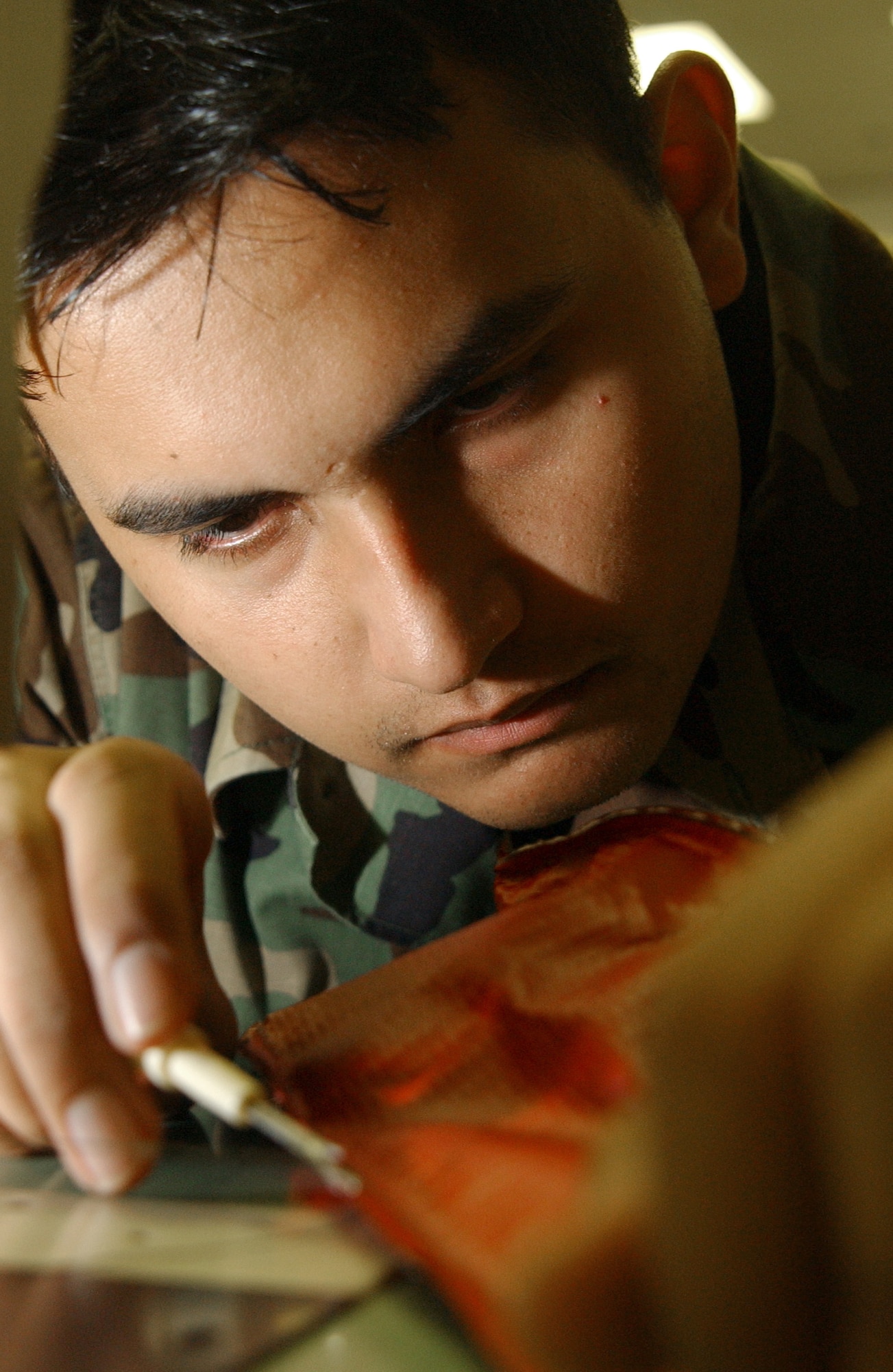 Airman 1st Class Joseph Elsey sews a cover for the exhaust of a KC-135 Stratotanker Wednesday, March 22, 2006, at MacDill Air Force Base, Fla. The exhaust covers are used to prevent water and other debris from entering the exhaust of an aircraft. He is a survival equipment apprentice with the 6th Maintenance Squadron. (U.S. Air Force photo/Airman 1st Class Bradley A. Lail)