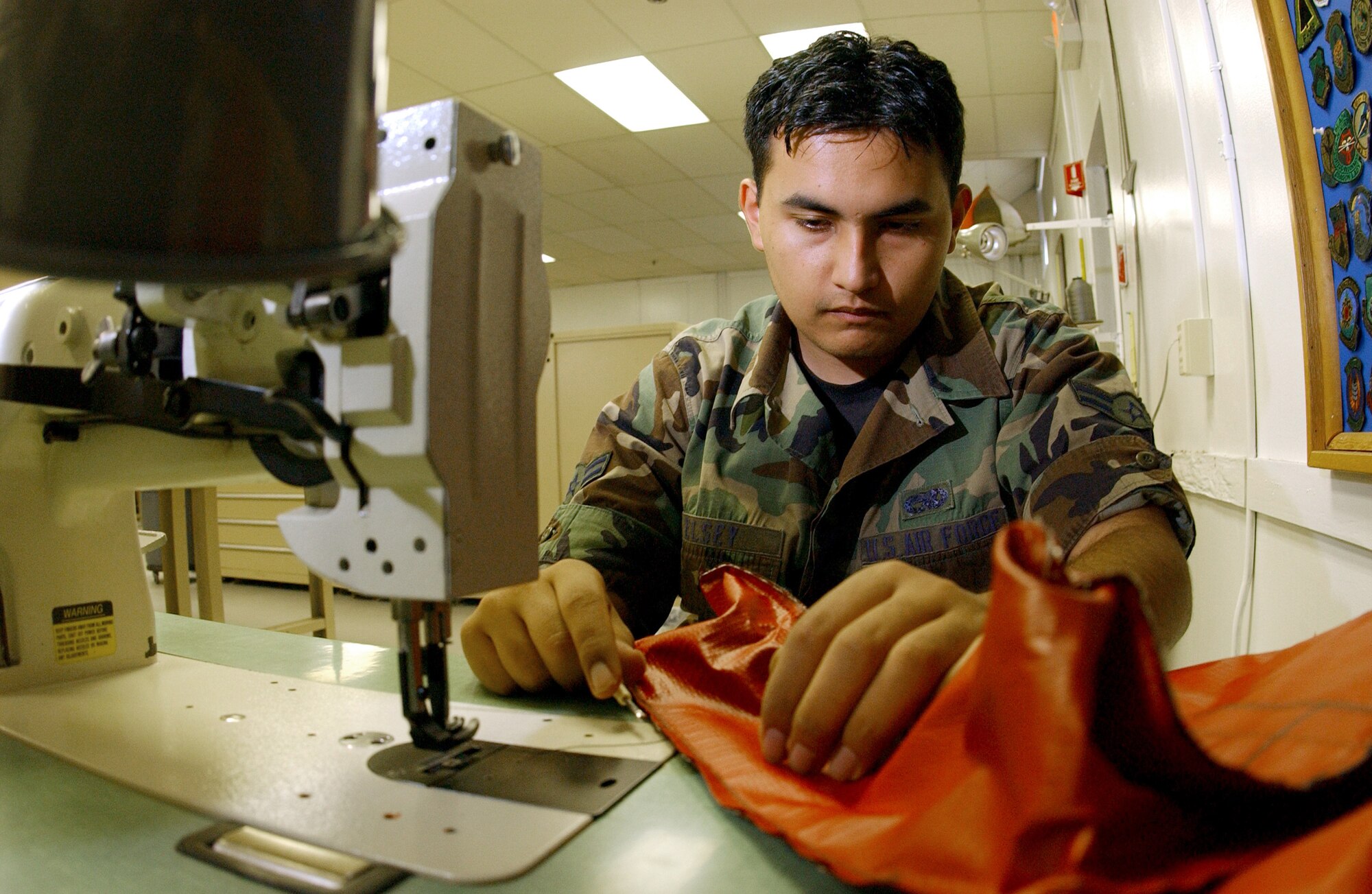 Airman 1st Class Joseph Elsey sews a cover for the exhaust of a KC-135 Stratotanker Wednesday, March 22, 2006, at MacDill Air Force Base, Fla. The exhaust covers are used to prevent water and other debris from entering the exhaust of an aircraft.  He is a survival equipment apprentice with the 6th Maintenance Squadron. (U.S. Air Force photo/Airman 1st Class Bradley A. Lail)