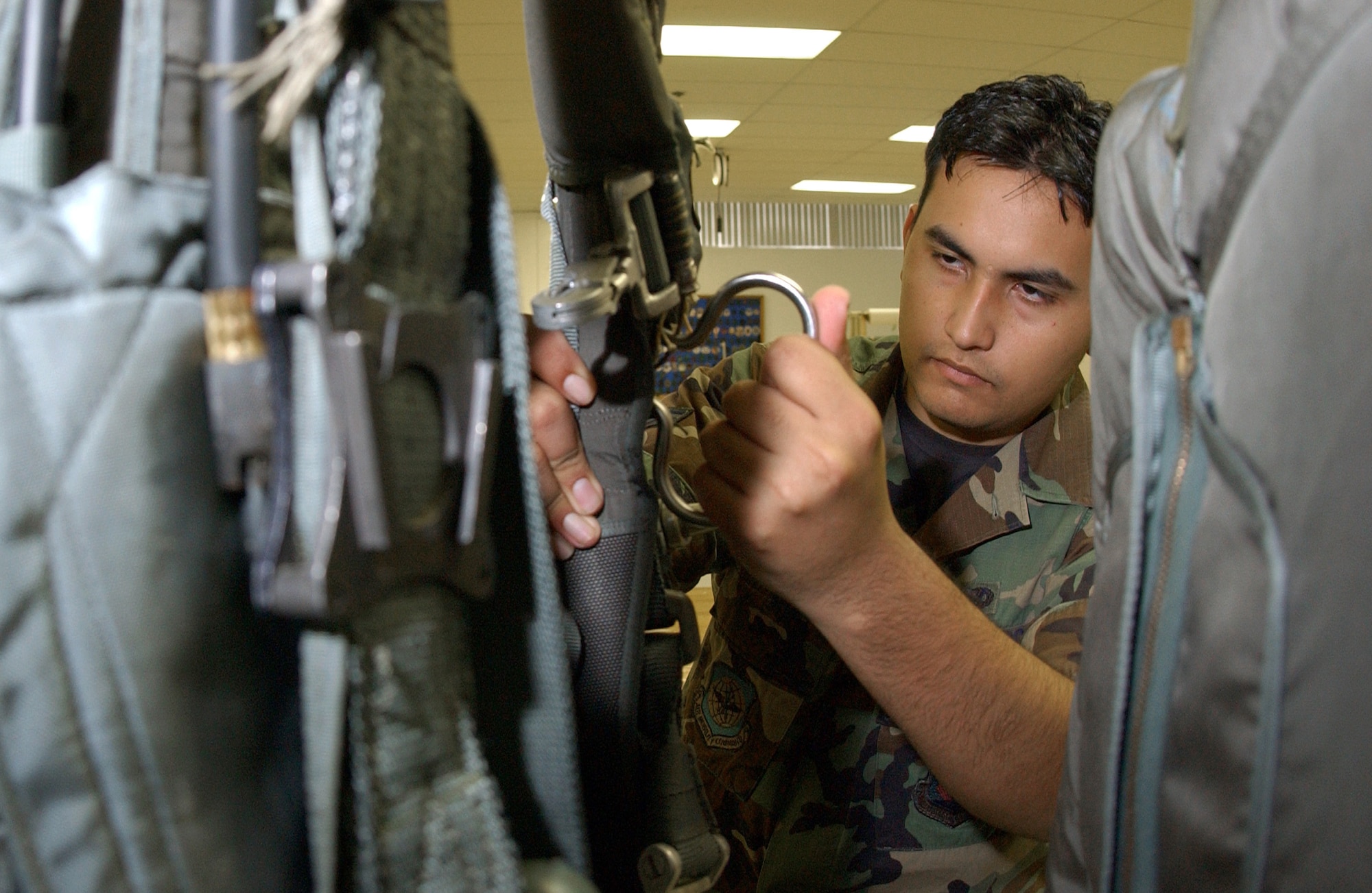 Airman 1st Class Joseph Elsey checks the tacking release on a back automatic parachute Wednesday, March 22, 2006, at MacDill Air Force Base, Fla.  Airman Elsey performs daily inspections on the BA-22 parachutes to ensure they are ready if needed in an emergency.  He is a survival equipment apprentice with the 6th Maintenance Squadron. (U.S. Air Force photo/Airman 1st Class Bradley A. Lail)