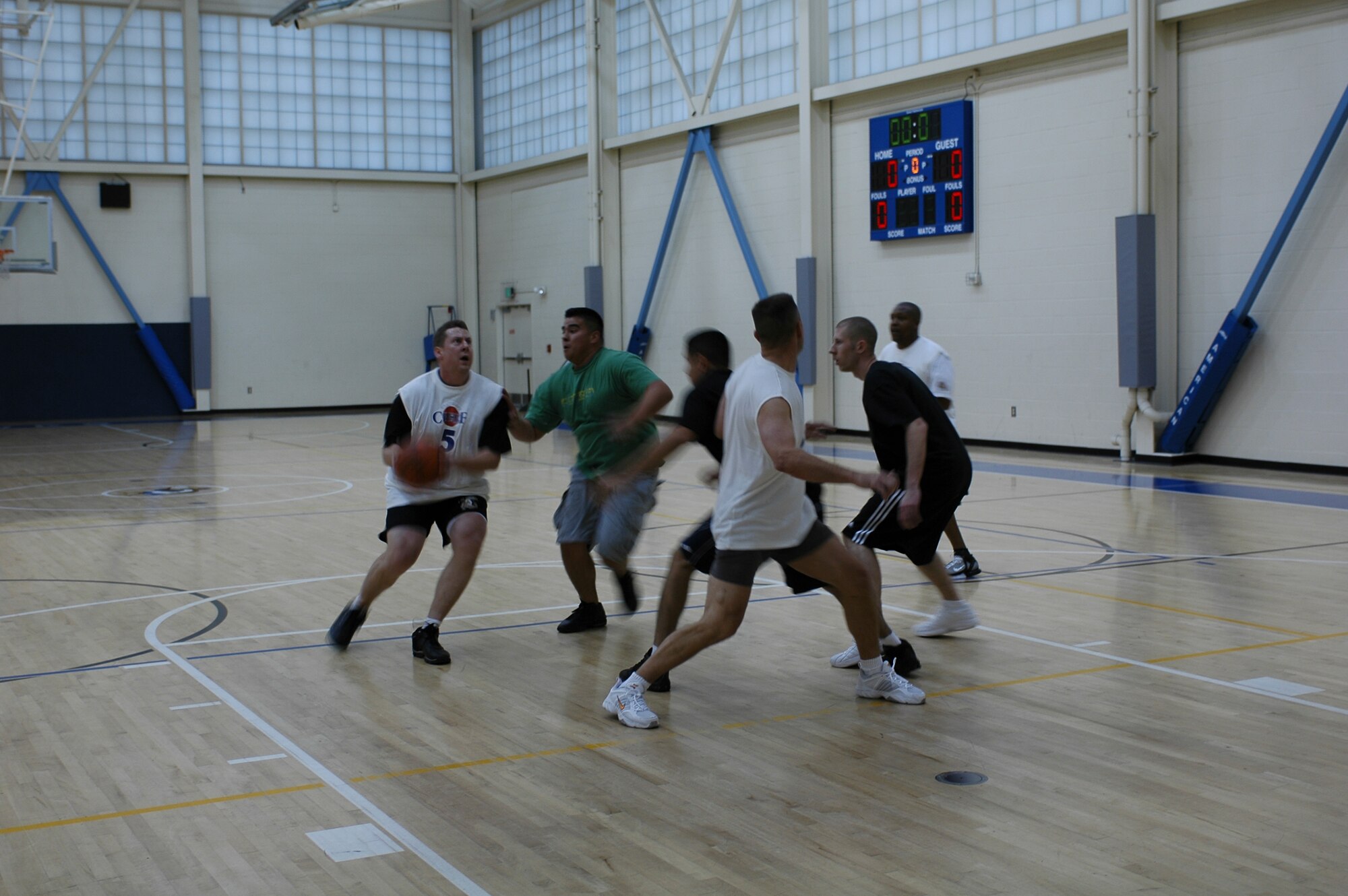 Joseph Mangum of the “Chiefs” team tries to pull a fake while waiting for James Tyson to go deep in the court. (U.S. Air Force photo by Jennifer Brugman)