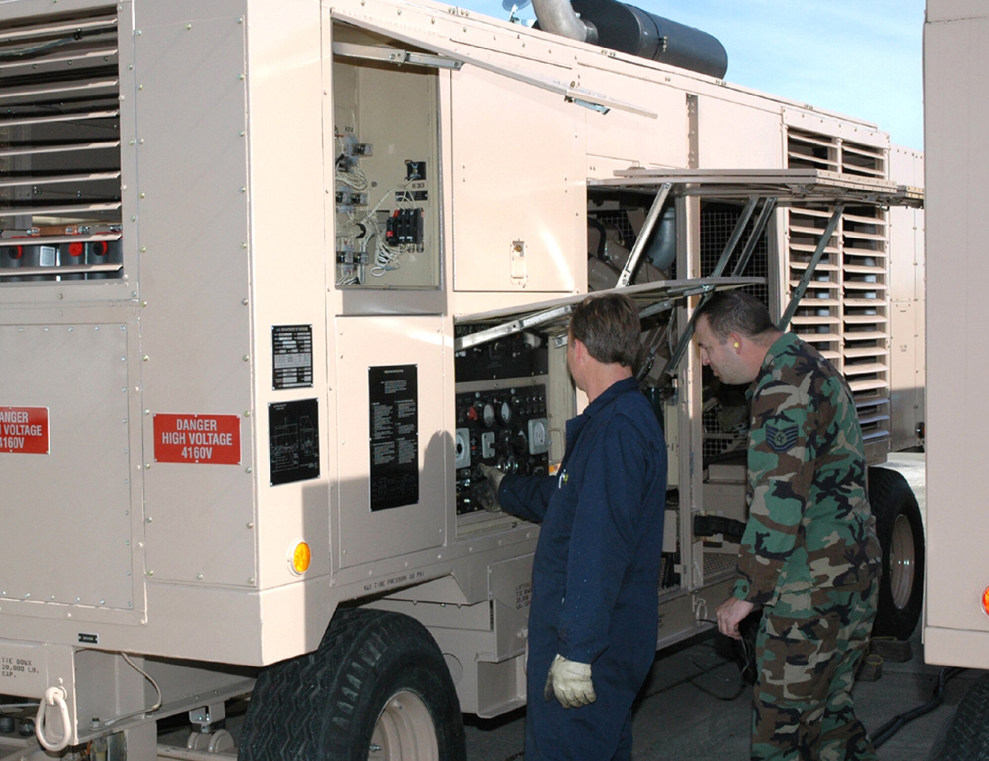 Mr. Michael Powers, a CEMIRT mechanic, and Technical Sgt. Matthew Thrasher, a CEMIRT electrician, run a generator after it has been rebuilt.  All units must be tested, checking for leaks and operational ability, prior to being shipped back to the customer. (U.S. Air Force photo by Staff Sgt. Raymond Hoy)