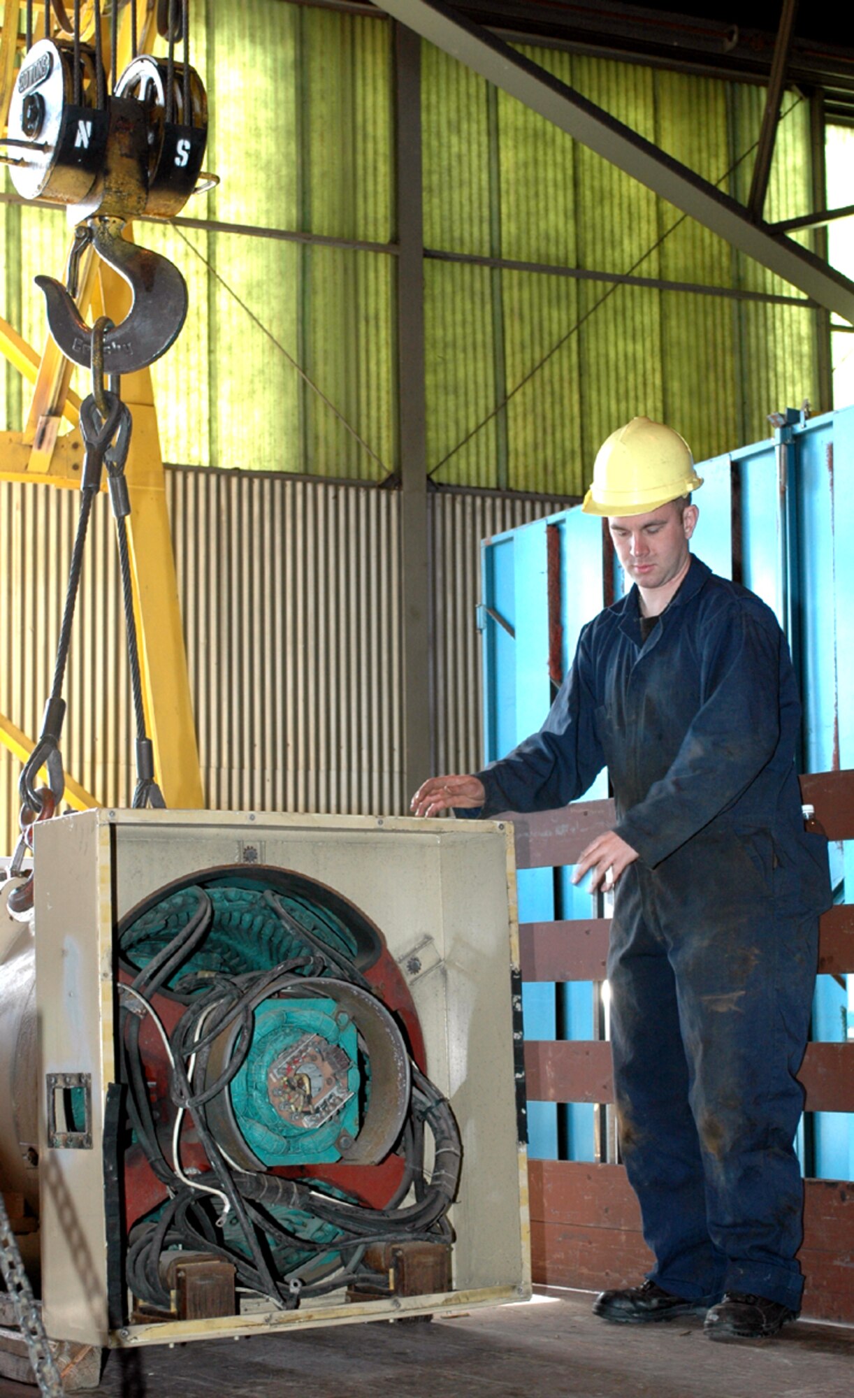 Staff Sgt. Jeremiah Hedgecock, a CEMIRT mechanic, helps load an alternator onto a truck for cleaning.  The alternators are thoroughly cleaned, inspected and tested before use.  Every part of the generator is inspected prior to reassembly. (U.S. Air Force photo by Staff Sgt. Raymond Hoy)