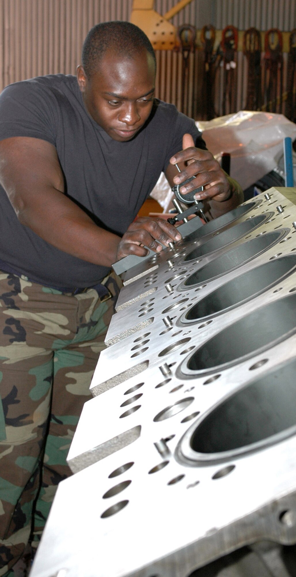 Staff Sgt. Tinashe Chinouyazve, a Civil Engineer Maintenance Inspection and Repair Team mechanic, takes different measurements of an engine block.  The engines are torn down to the block and taken downtown for cleaning.  After the blocks are returned to CEMIRT, the team completes a series of measurements to ensure the block is ready for reassembly. (U.S. Air Force photo by Staff Sgt. Raymond Hoy)