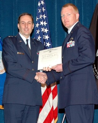 Maj. Gen. Craig E. Campbell (left) presents 2nd Lt. Michael Maule his Certificate upon completion of the Academy of Military Science's six-week commission course. Maule also received the Class Speaker Award. Campbell is the Adjutant General for the State of Alaska, commander of the Alaska National Guard and the Commissioner of the Department of Military and Veterans Affairs.