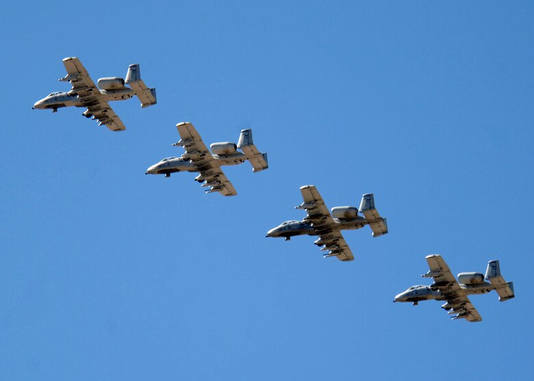 Four A-10 Thunderbolt IIs fly into Davis-Monthan Air Force Base, Ariz., Wednesday, March 22, 2006, to kick off the beginning of "Hawgsmoke 2006," the 30th anniversary of the Warthog. Hawgsmoke is a biennial bombing and tactical gunnery competition of the A-10, in which 20 squadrons worldwide come together to fly the Warthog and compete for the honor of the "Best of the Best" in ground attack and target destruction. (U.S. Air Force photo/Senior Airman Christina D. Ponte)