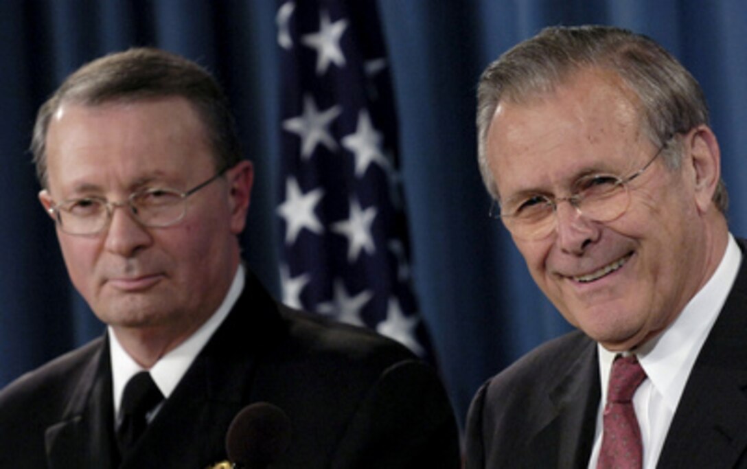 Secretary of Defense Donald H. Rumsfeld and Vice Chairman of the Joint Chiefs of Staff Adm. Edmund G. Giambastiani Jr., U.S. Navy, listen to a question during a Pentagon press briefing in Arlington, Va., on March 23, 2006. Rumsfeld and Giambastiani talked to reporters about the current situation in Iraq. Rumsfeld also announced his upcoming trip to the crash site of Sept. 11, 2001, United Flight 93 in Shanksville, Pa. 