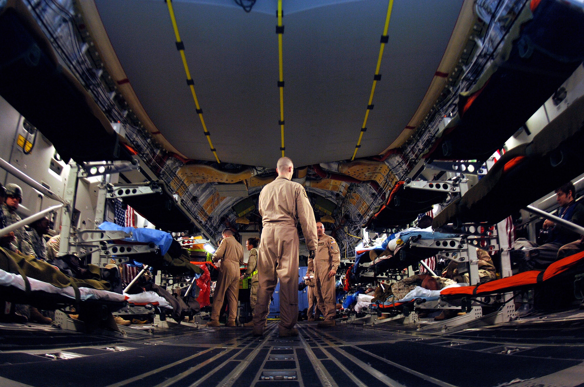 U.S. Air Force aeromedical staging flight personnel transport wounded service members from a C-17 Globemaster III onto buses to be transported to the ASF at Scott Air Force Base, Illinois, May 15, 2010. (U.S. Air Force photo by Senior Airman Ryan Crane)