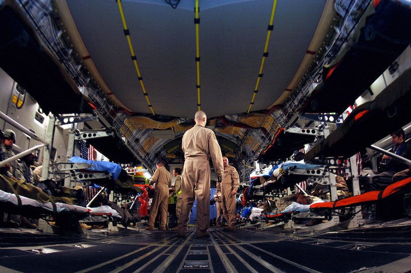 U.S. Air Force aeromedical staging flight personnel transport wounded service members from a C-17 Globemaster III onto buses to be transported to the ASF at Scott Air Force Base, Illinois, May 15, 2010. (U.S. Air Force photo by Senior Airman Ryan Crane)