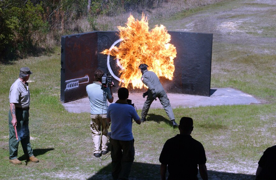 R. Lee Ermey, host of the Mail Call military technology show,  watches the effects of a molotov cocktail thrown by Lt Col Gary Reynolds, USAF Special Operations School instructor, during a weapons demonstration by the cadre of Dynamics in Terrorism at Hurlburt Field, Fla..  "Gunny" Ermey toured the USAF Special Operations School during his recent visit here for an upcoming episode of the show focusing on Air Force Special Operations Command.  During his visit he sat in on a Middle Eastern Orientation class, watched a demonstration on vehicle search techniques, received a breifing on weapons used by terrorists around the world and fired an Israeli Galil and a Styer-aug.  "Gunny" Ermey, a retired Marine, is well known both for hosting the show and for his role as a tough-as-nails drill instructor in the film "Full Metal Jacket."