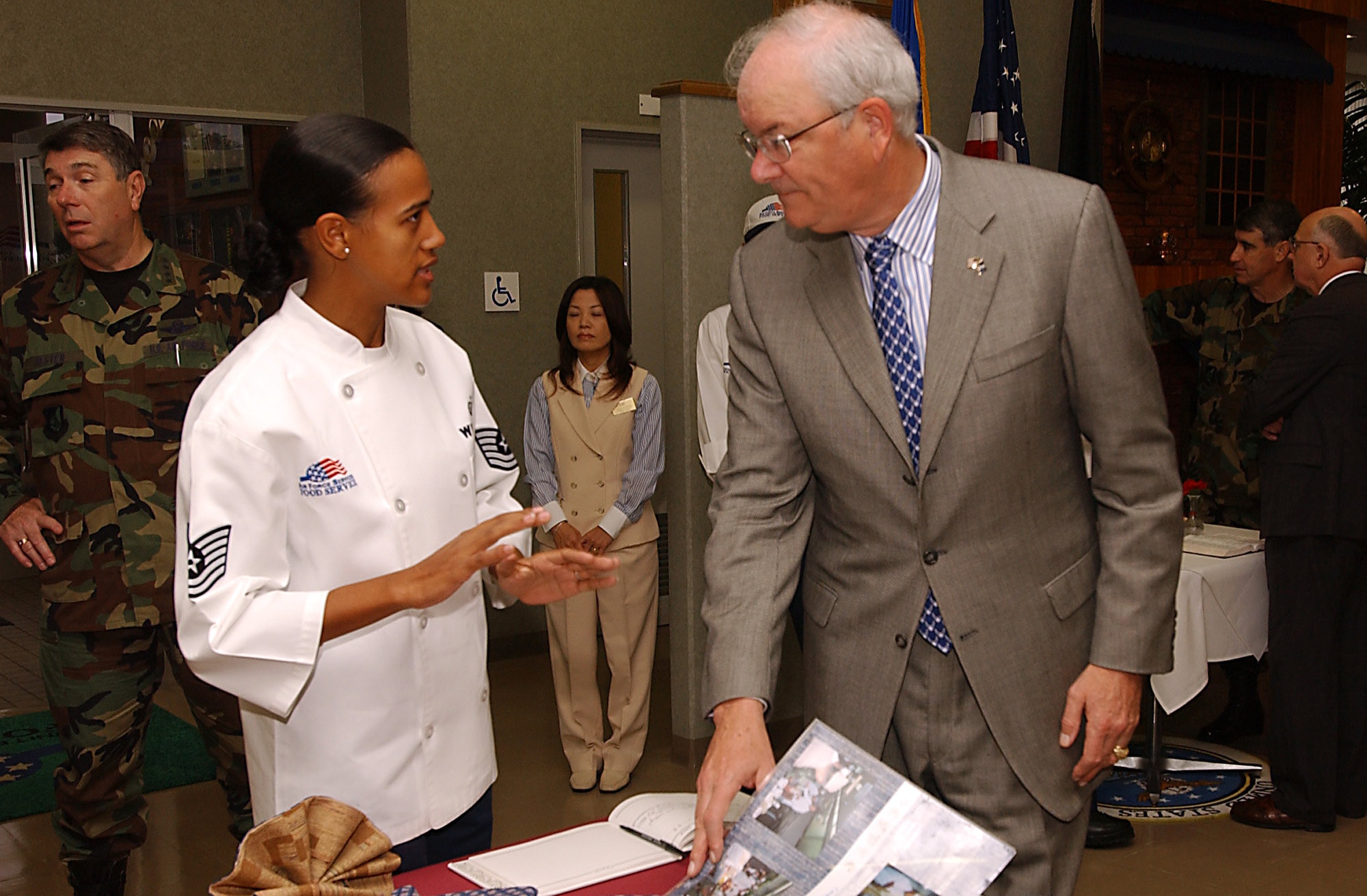 Tech. Sgt. Ashley Williams explains the Marshal Dinning facility operations to Secretary of the Air Force Michael W. Wynne during his base tour of Kadena Air Base, Japan, Thursday, March 23, 2006.  (U.S. Air Force photo/Airman 1st Class Stephanie Sinclair)