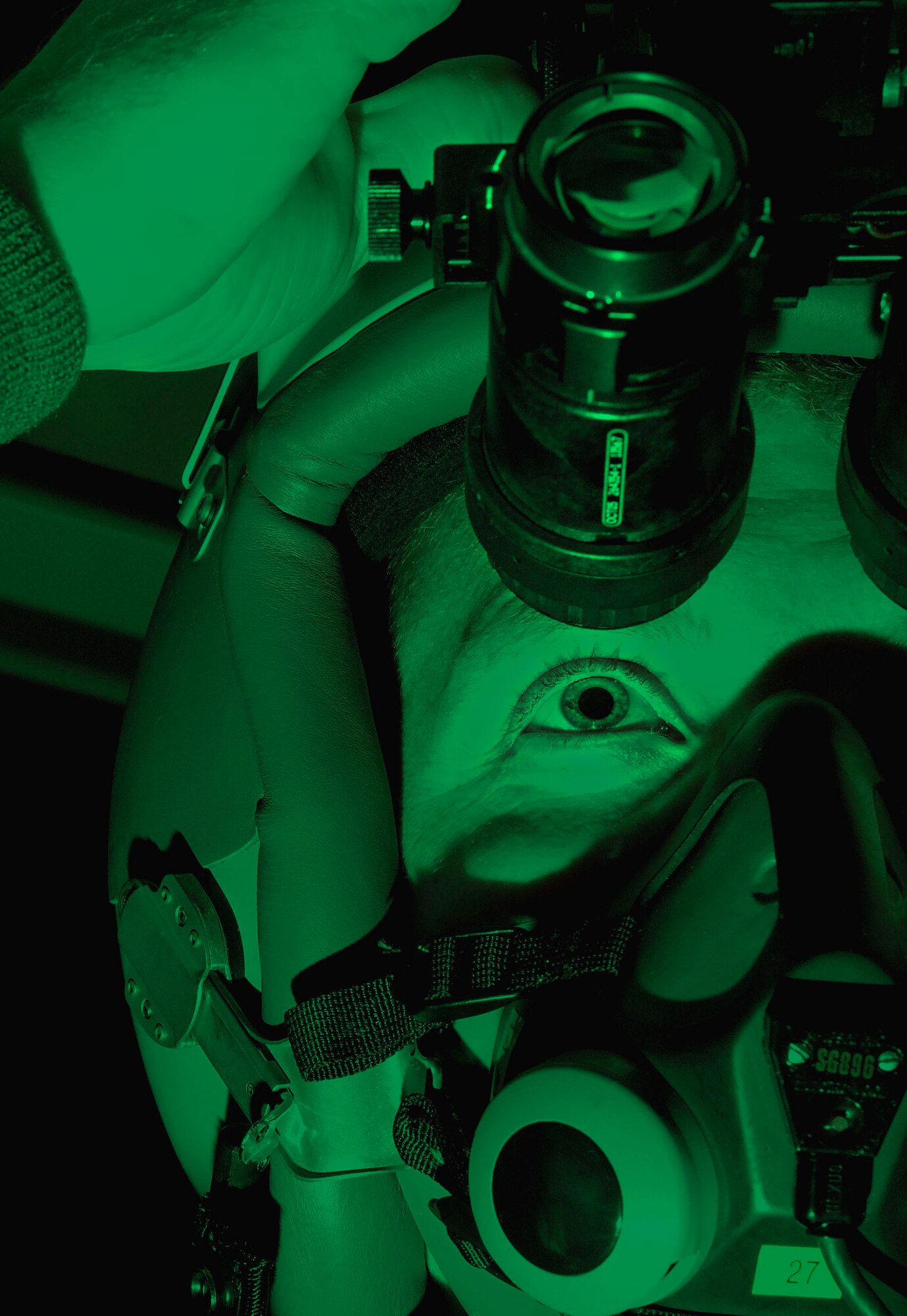 Capt. Brian Beales tests his night vision goggles before a night sortie Tuesday, March 21, 2006, at Langley Air Force Base, Va.  Captain Beales is with the 27th Fighter Squadron.  (U.S. Air Force photo/Senior Airman Austin Knox) 