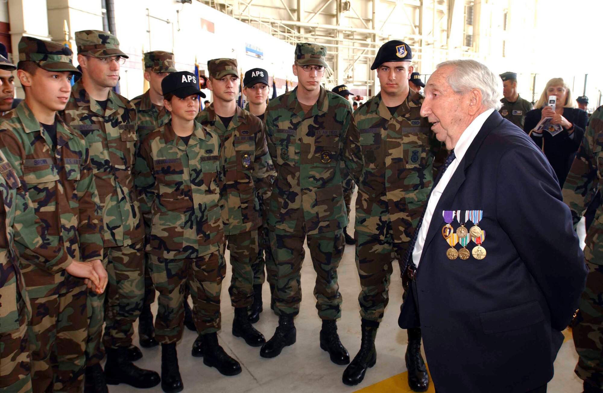 Leo Bach, a World War II veteran, speaks with Airmen after a medal ceremony at Travis Air Force Base, Calif. March 21. (U.S. Air Force courtesy photo)