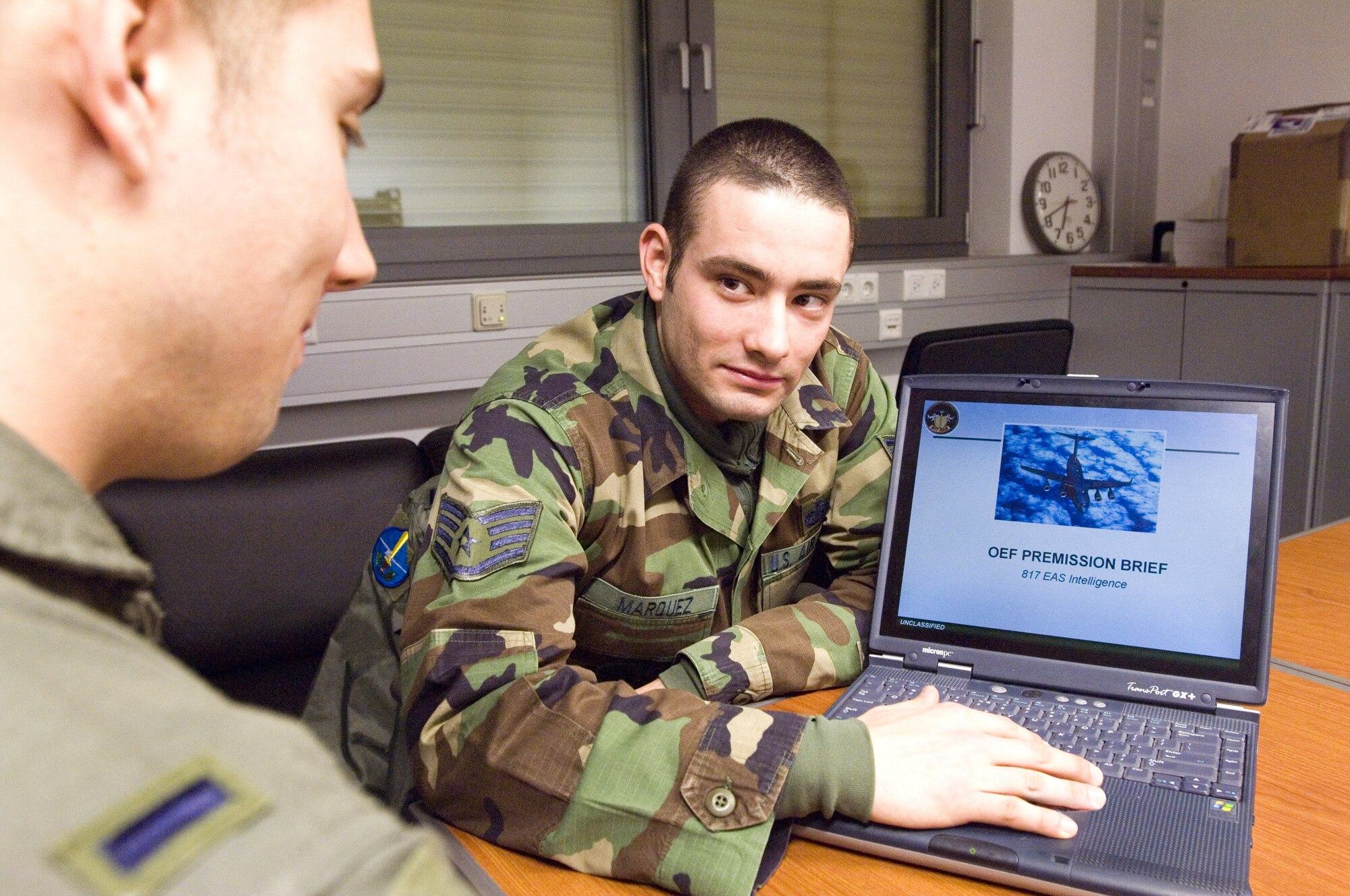 Staff Sgt. Tony Marquez, right, reviews an intelligence briefing with 1st Lt. Brad Peregrin at Spangdahlem Air Base, Germany, on Thursday, March 23, 2006. Both Sergeant Marquez, from Chicago, and Lieutenant Peregrin, of Colorado Springs, Colo., are on temporary duty with Detachment 5, 817th Expeditionary Airlift Squadron at Spangdahlem. Sergeant Marquez is an intelligence specialist permanently with the 305th Operational Support Squadron at McGuire Air Force Base, N.J. The lieutenant is a C-17 Globemaster III pilot with the 7th Airlift Squadron at McChord Air Force Base, Wash. (U.S. Air Force photo/Master Sgt. John E. Lasky) 
