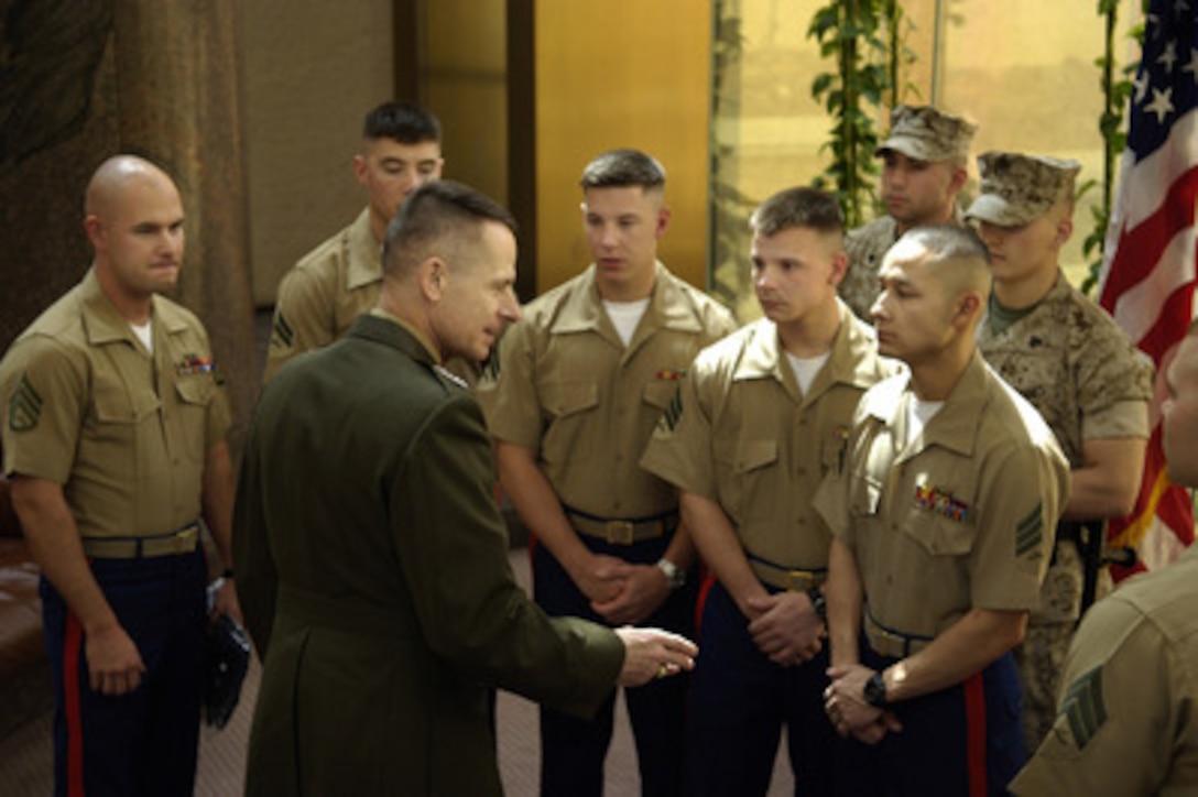 Chairman of the Joint Chiefs of Staff Gen. Peter Pace (2nd from left), U.S. Marine Corps, talks with Marines assigned to the U.S. Embassy in Riyadh, Saudi Arabia, on March 22, 2006. 