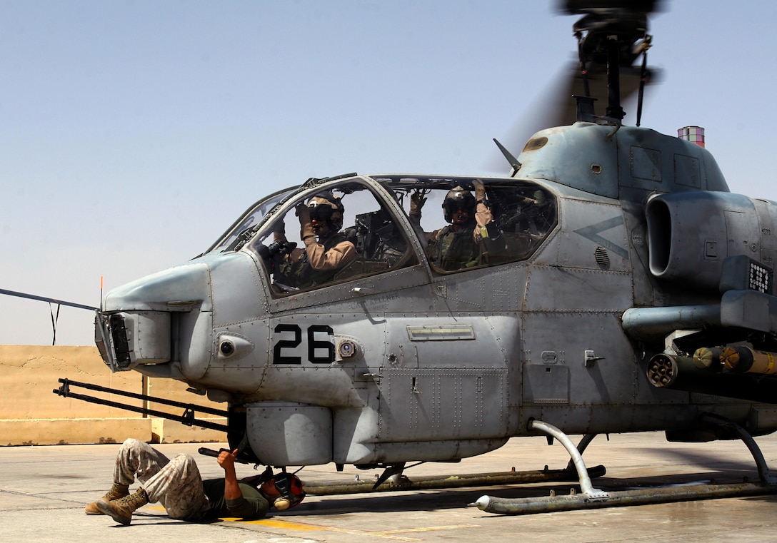 Lance Cpl. Micah E. Vogen puts a AH-1W Super Cobra helicopter's M197 20mm automatic gun on safe, after the helicopter returns from a mission to Al Taqaddum, Iraq, March 25. Vogen and the ordnance division Marines with Marine Light Attack Helicopter Squadron 369, Marine Aircraft Group 16 (Reinforced), 3rd Marine Aircraft Wing, are responsible for quickly arming Cobras and UH-1N Hueys before they fly out on missions. Vogen is an aircraft ordnance technician and Kansas City, Mo., native.