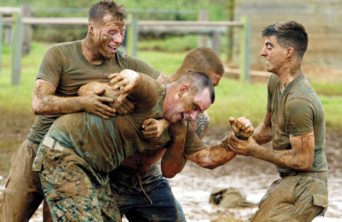 Members of a CSSG-3 team celebrate finishing the race with some playful wrestling. This was the biggest turnout for the race that saw more than 2,000 people show up to race, volunteer or just to cheer on their favorite team.