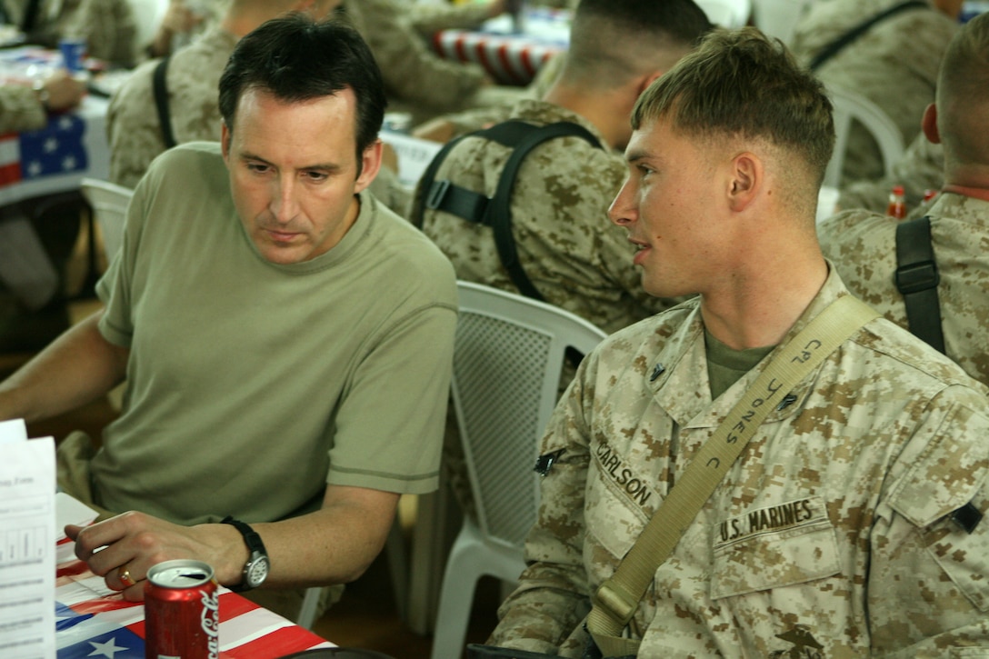 Corporal David J. Carlson, a member of Maj. Gen. Richard C. Zilmer's personal security detachment, from St. Paul, Minn., speaks with Tim Pawlenty, the Governor of Minnesota, while eating at one of the chow halls at Camp Fallujah, Iraq March 26, 2006. Pawlenty along with eight other congressional delegates came to Iraq to visit with staff members of both Multi-National Forces-Iraq and MNF-West to discuss the progress made in the region. The congressional delegates also took time to sit down with Marines, sailors and soldiers from their home states at a Camp Fallujah dining facility. Among the distinguished guests were, Sen. John McCain, from Arizona, Sen. Russell Feingold, from Wisconsin, Sen. John Thune, from South Dakota, Rep. Mark Kirk, from Illinois, Rep. Joe Schwarz, from Michigan, Rep. Tom Udall, from New Mexico, Gov. Tim Pawlenty, from Minnesota, Gov. Bob Riley, from Alabama and Gov. Jon Huntsman, from Utah.  (Photo by Cpl. Jon C. Guibord)