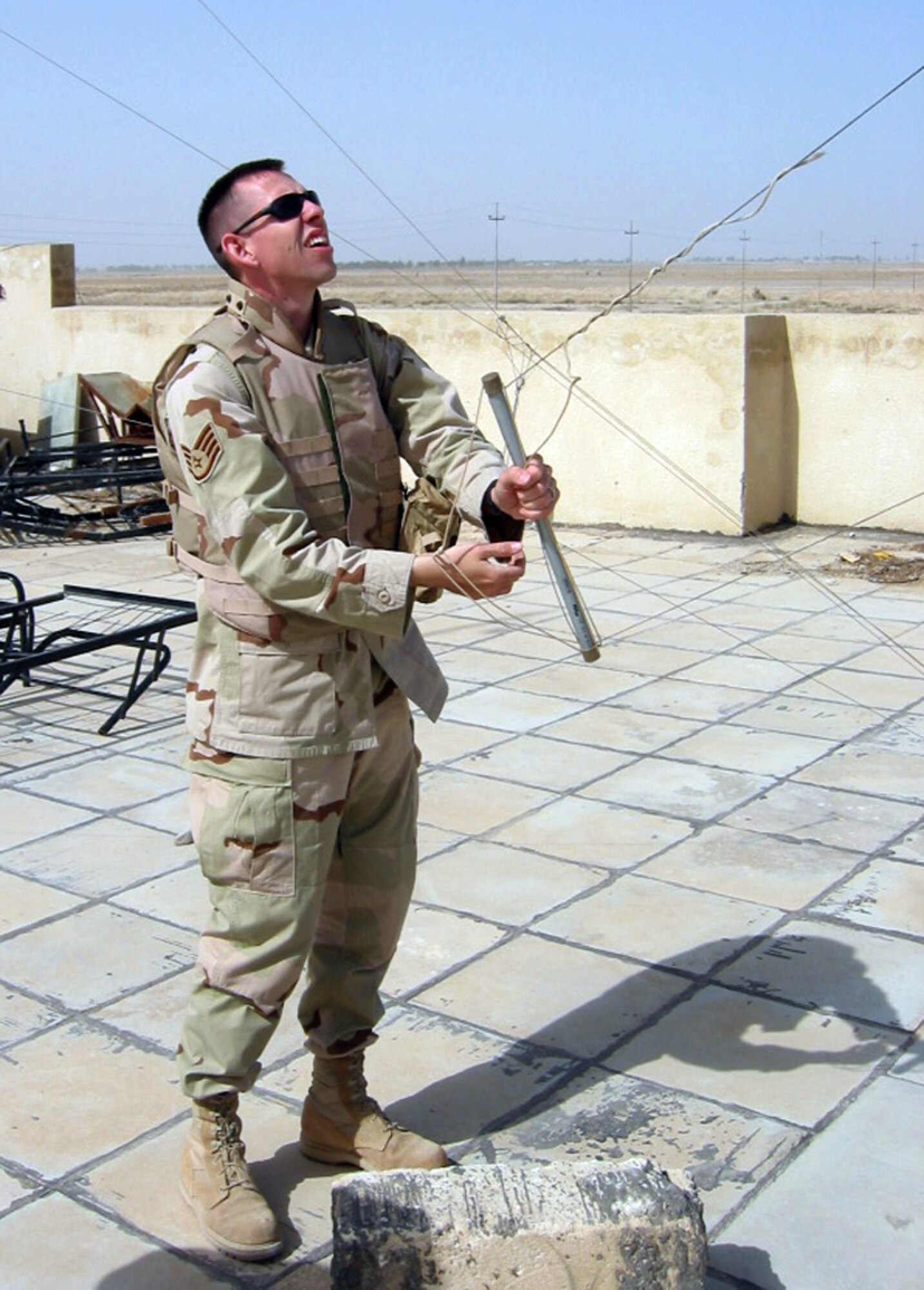 Staff Sgt. Chris Birdwell adjusts a high frequency antenna on top of an Iraqi police station. He is assigned to the 407th Expeditionary Communications Squadron. (U.S. Air Force photo/Capt. Randy Witt) 

