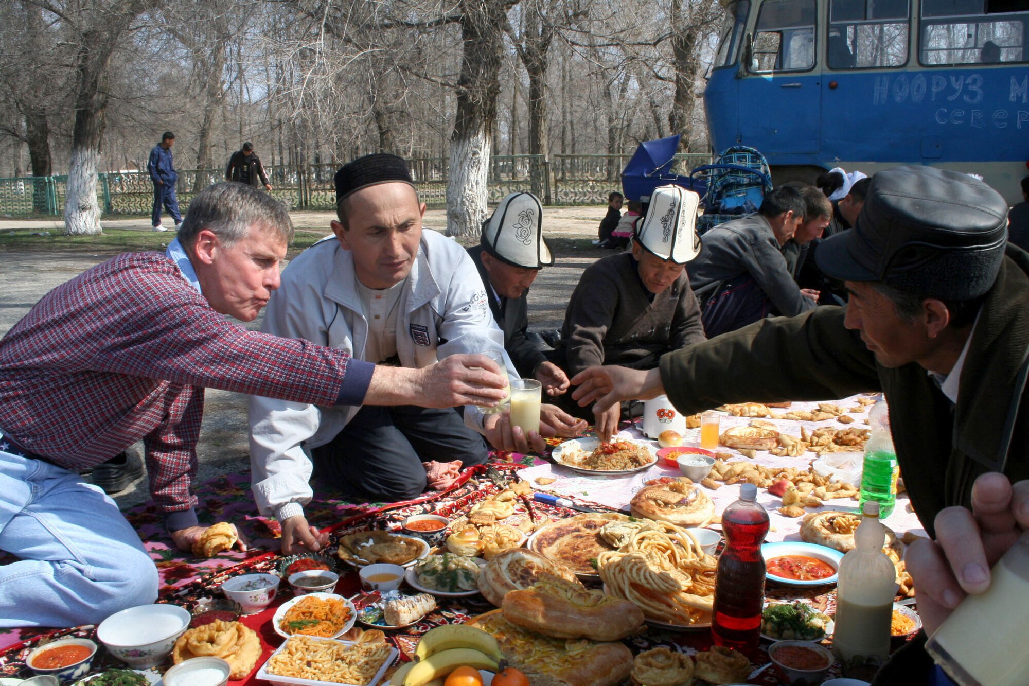 Col. Bill Baird shares a glass of bozo (buh-zoh) with a family at a celebration in Jani Jer, a village outside of Manas Air Base, Kyrgyzstan, March 22, 2006, after the family spontaneously invited him and other wing leaders to join their meal. The wing leaders were invited by Mayor Batyrlan Kulov to join his village in celebrating Nooruz, a New Year celebration in some Muslim traditions, after Colonel Baird visited the village during a new outreach initiative in February. The colonel is commander of the 376th Expeditionary Mission Support Group. (U.S. Air Force photo/Staff Sgt. Lara Gale) 