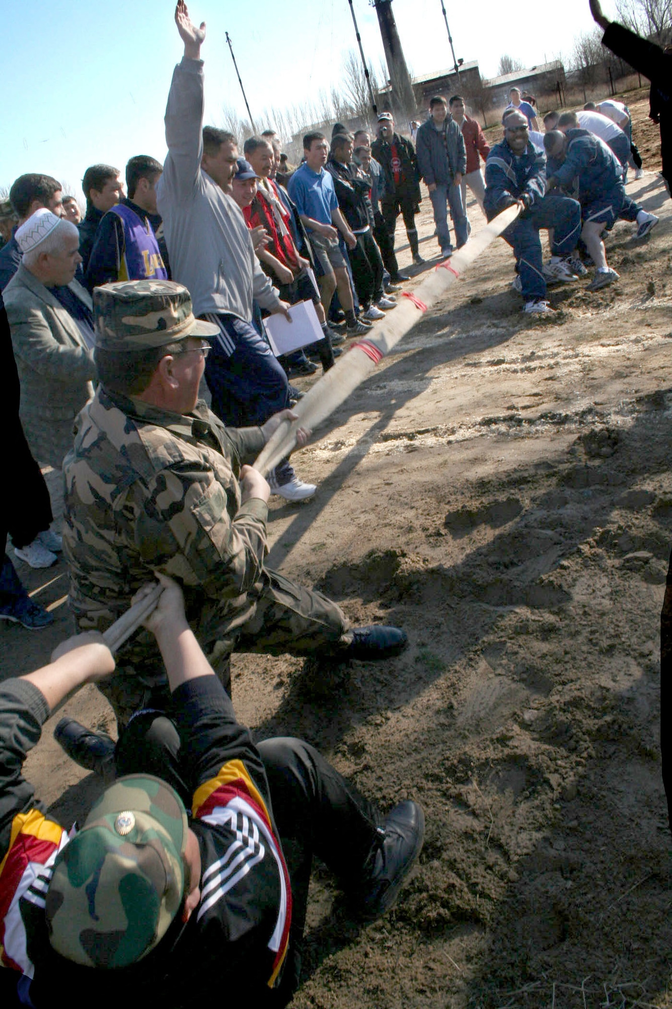 Airmen struggle against a team of Manas International Airport personnel determined to pull them over the line in a tug-of-war competition as part of Revolution Day celebrations Thursday, March 23, 2006, in Kyrgyzstan. The airport's secretary of security, Mamyrov Nadybek, invited the Airmen to participate in the games as a mark of friendship and mutual respect. The day included races, tournaments and strength competitions. (U.S. Air Force photo/Staff Sgt. Lara Gale)