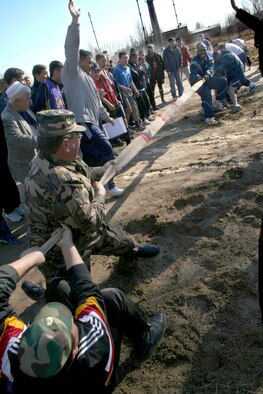 Airmen struggle against a team of Manas International Airport personnel determined to pull them over the line in a tug-of-war competition as part of Revolution Day celebrations Thursday, March 23, 2006, in Kyrgyzstan. The airport's secretary of security, Mamyrov Nadybek, invited the Airmen to participate in the games as a mark of friendship and mutual respect. The day included races, tournaments and strength competitions. (U.S. Air Force photo/Staff Sgt. Lara Gale)