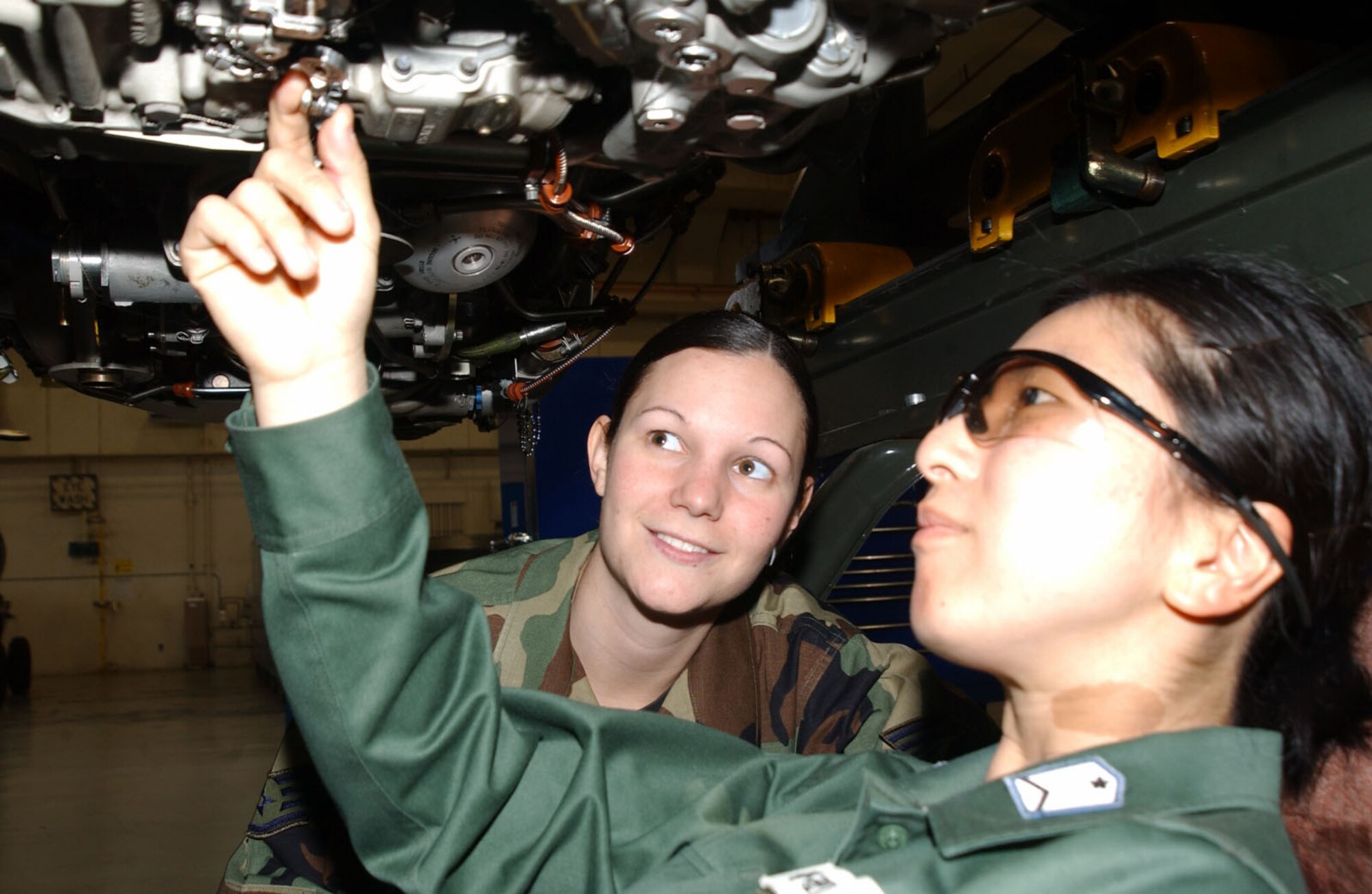 Japan Air Self-Defense Force Staff Sgt. Aiko Koba and Air Force Staff Sgt. Tatiana Albrecht, 18th Component Maintenance Squadron, review different methods of maintenance during an exchange visit at Kadena Air Base, Japan, March 13 to 23, 2006. Sergeant Shiroi is one of seven Japanese NCOs who visited Kadena as part of the JASDF-U.S. Air Force Bilateral Exchange Program. The program is designed to enhance NCO relationships, share culture and professional military ideas, and gain a better understanding of allied operations. (U.S. Air Force photo/Airman Ryan Ivacic) 
