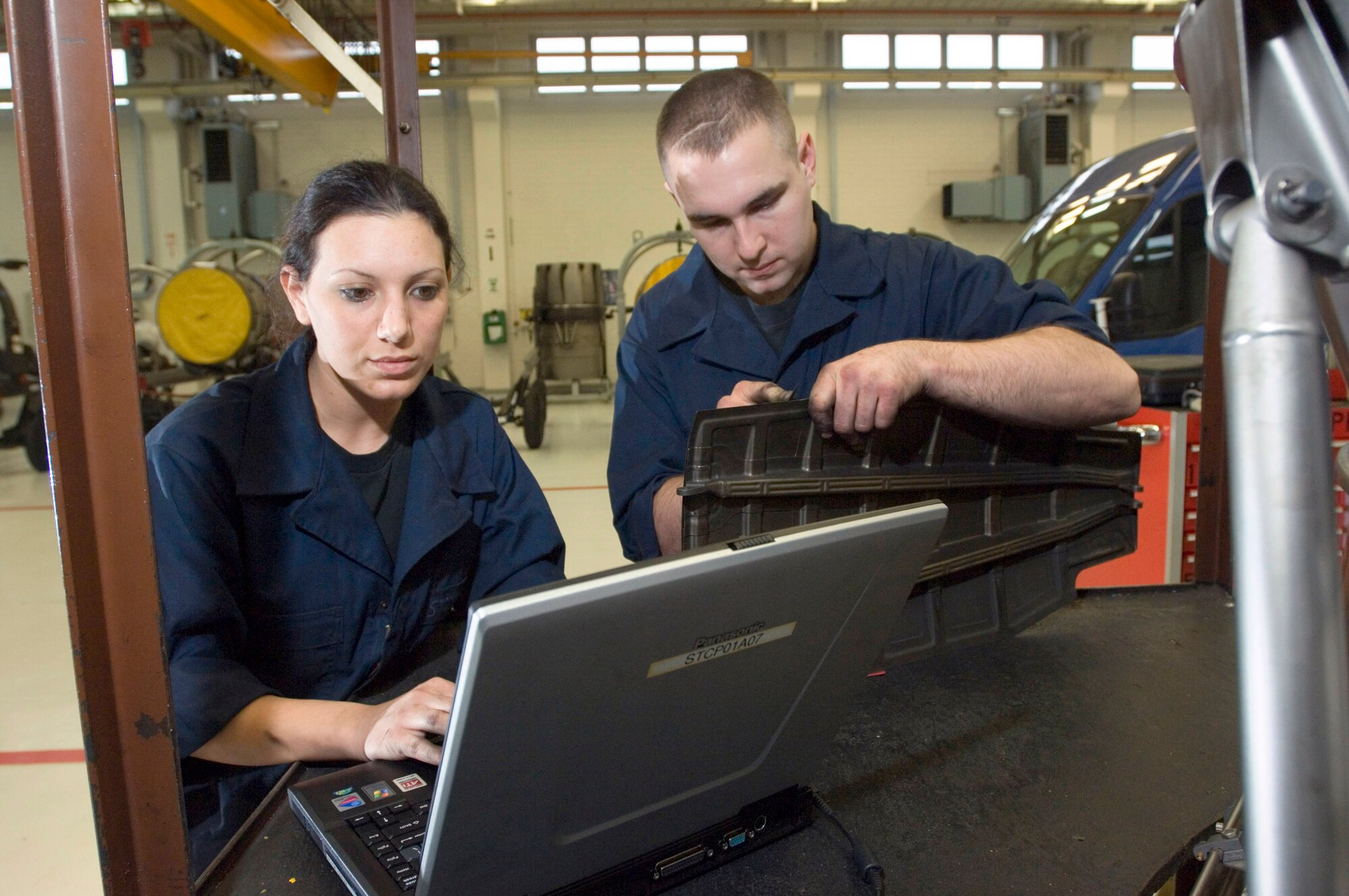 Senior Airmen Nicole Balderas and Ronald Craven repair F-16 Fighting Falcon jet engines at Spangdahlem Air Base, Germany, on Friday, March 24, 2006. Airman Balderas, of Carbondale, Penn., and Airman Craven, an air reservist from Long Beach, Calif., are jet engine mechanics with the 52nd Component Maintenance Squadron's propulsion flight. (U.S. Air Force photo/Master Sgt. John E. Lasky)