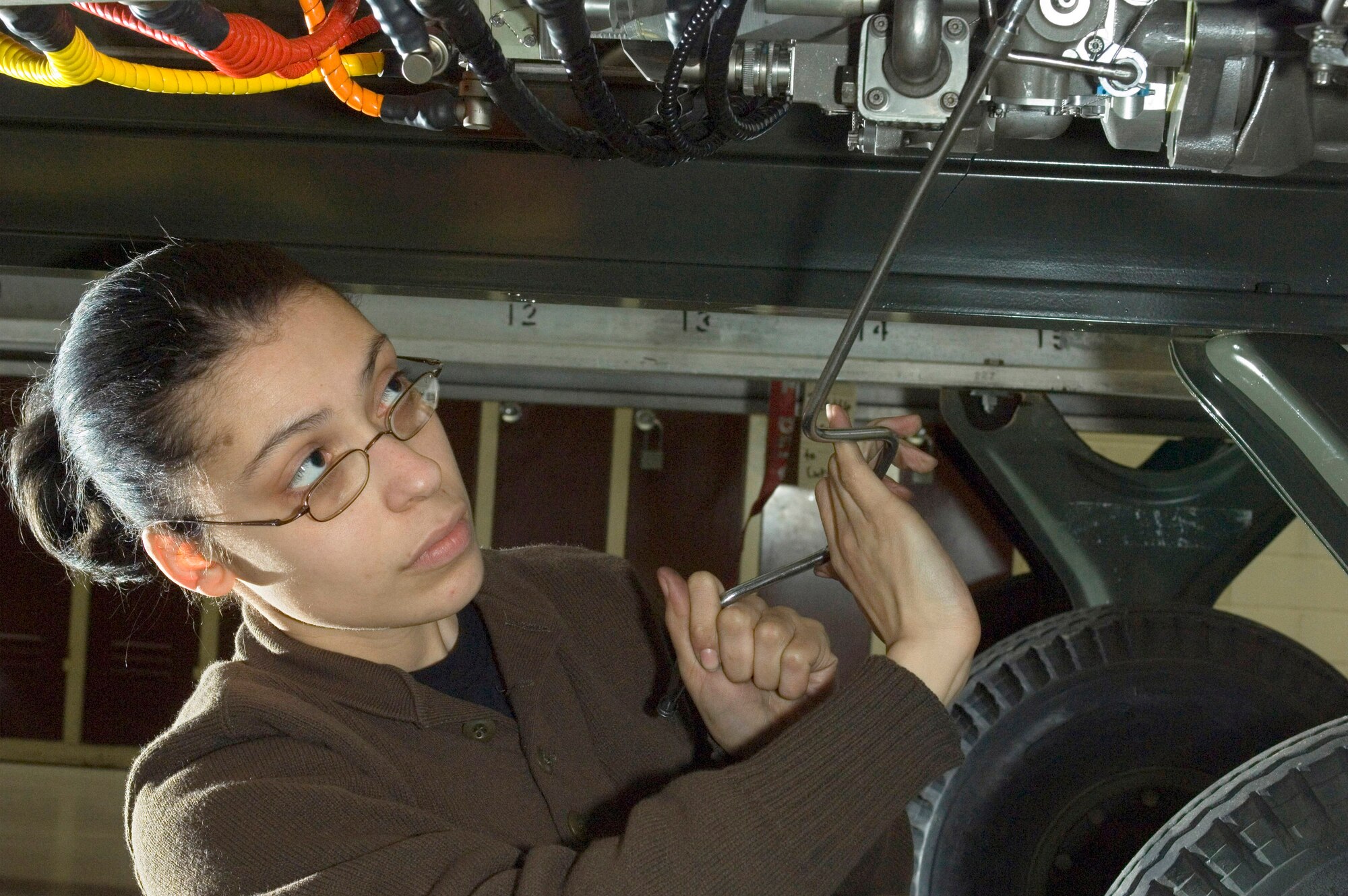 Airman First Class Jacquelynn Mathews changes the bolts on an F-16 Fighting Falcon jet engine at Spangdahlem Air Base, Germany, on Friday, March 24, 2006. Airman Mathews of Lawton, Okla., is a jet engine mechanic with the 52nd Component Maintenance Squadron's propulsion flight. (U.S. Air Force photo/Master Sgt. John E. Lasky)
