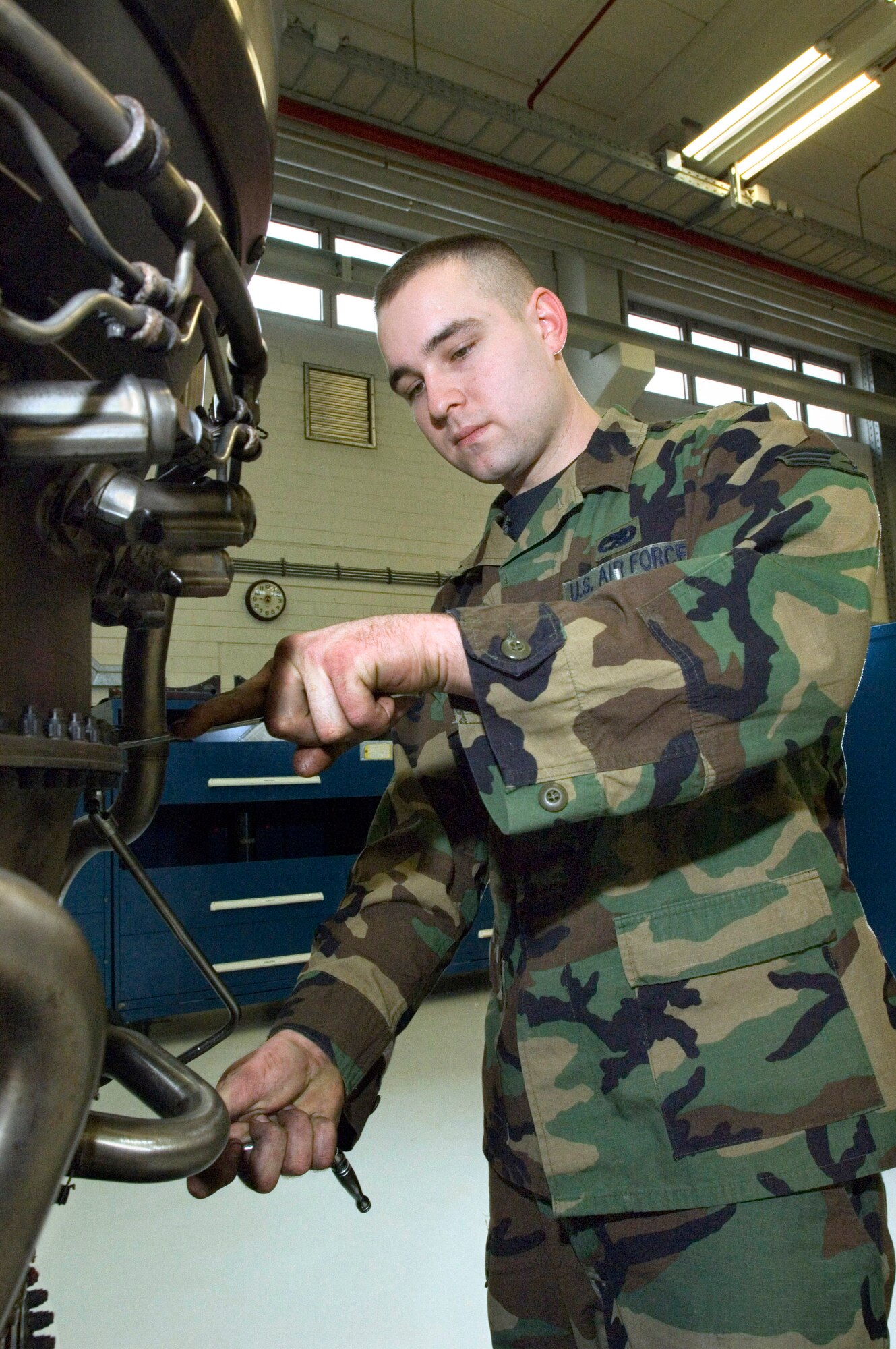 Senior Airman Ronald Craven works on an F-16 Fighting Falcon jet engine at Spangdahlem Air Base, Germany, on Friday, March 24, 2006. Airman Craven, of Long Beach, Calif., is a jet engine mechanic with the 52nd Component Maintenance Squadron's propulsion flight. (U.S. Air Force photo/Master Sgt. John E. Lasky)
