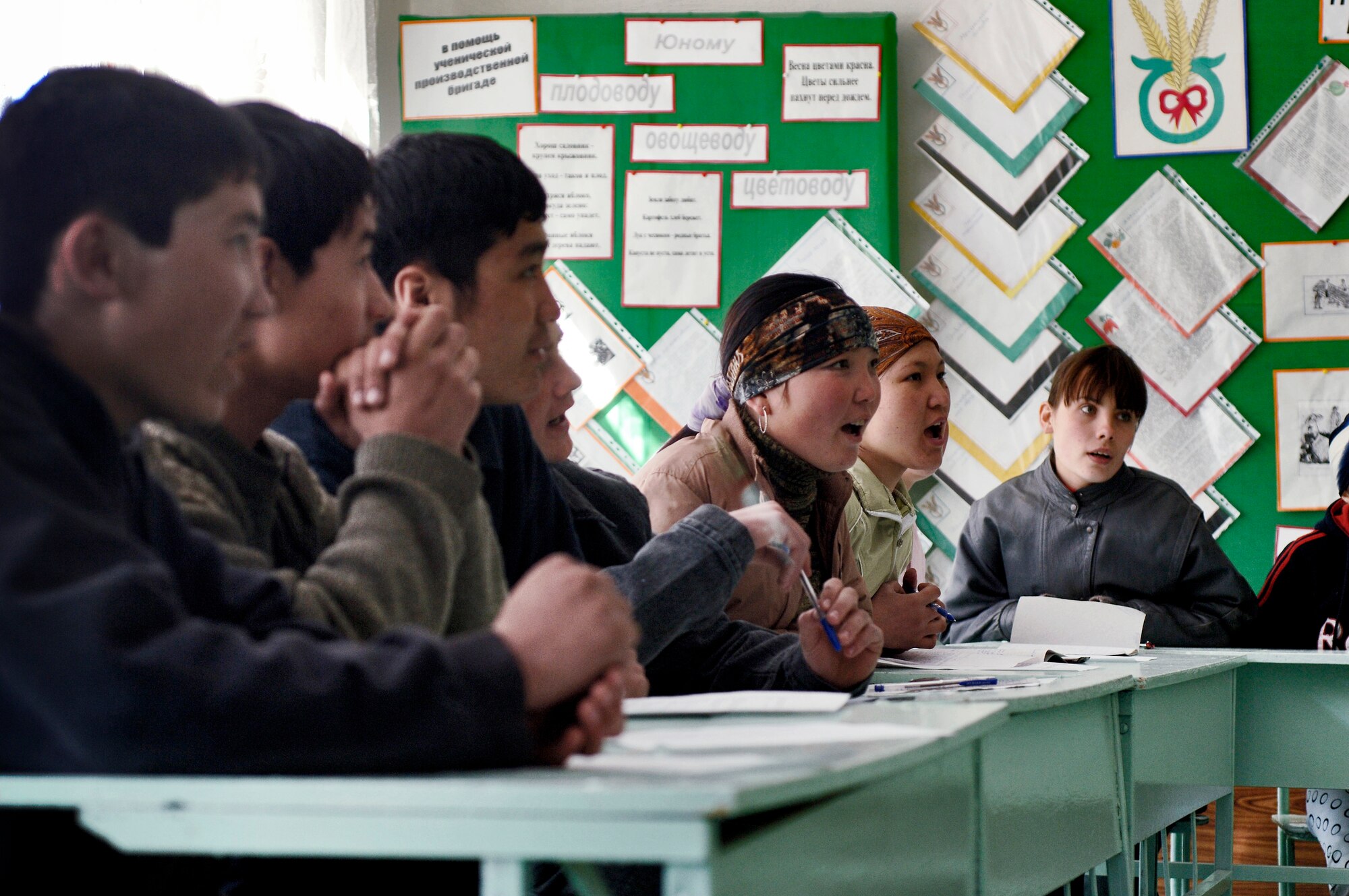 Students respond to Airmen tutoring them in English at Lyceum Vocational School in Kyrgyzstan.  The in-residence vocational school is home to more than 200 local boys and girls, ages 14 to 18. Manas Air Base Outreach Society is a non-profit organization established at Manas Air Base in December 2003. Lyceum is one of its several focus groups. (U.S. Air Force photo/Master Sgt. Lance Cheung)