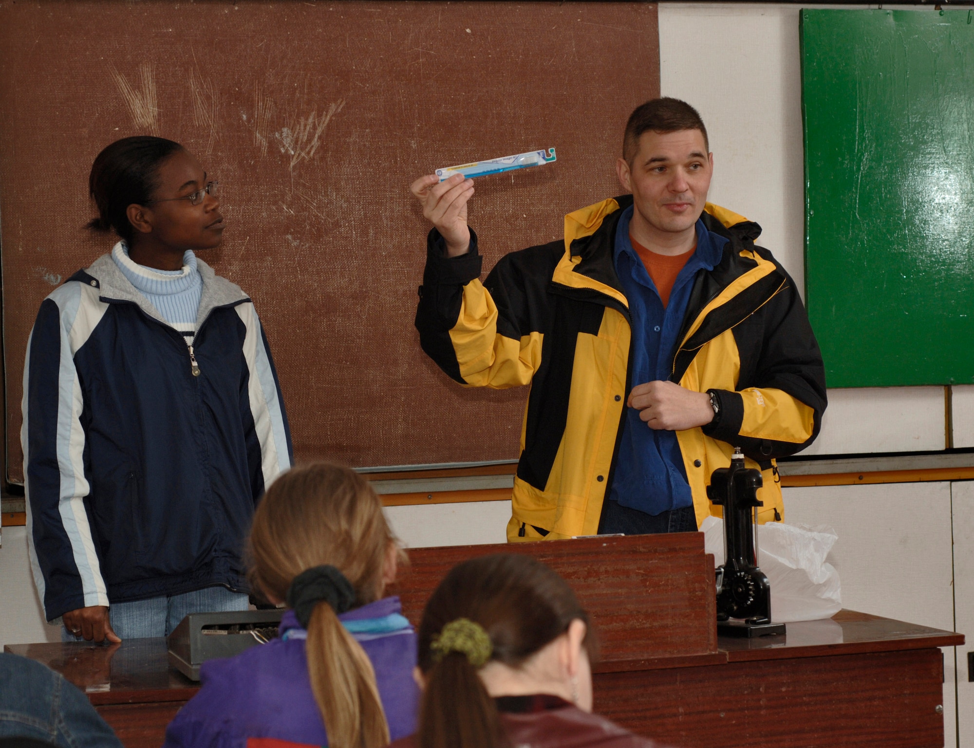 Capt. Arnold Sauve (holding a toothbrush) and Airman 1st Class Chiquita Ferdinand use common objects to tutor students in English at Lyceum Vocational School in Kyrgyzstan.  The in-residence vocational school is home to more than 200 local boys and girls, ages 14 to 18. Captain Sauve is deployed from Barksdale Air Force Base, La., to the 376th Expeditionary Medical Squadron at Manas Air Base. Airman Ferdinand is deployed from Whiteman AFB, Mo., to the 376th Expeditionary Mission Support Group. (U.S. Air Force photo/Master Sgt. Lance Cheung)
