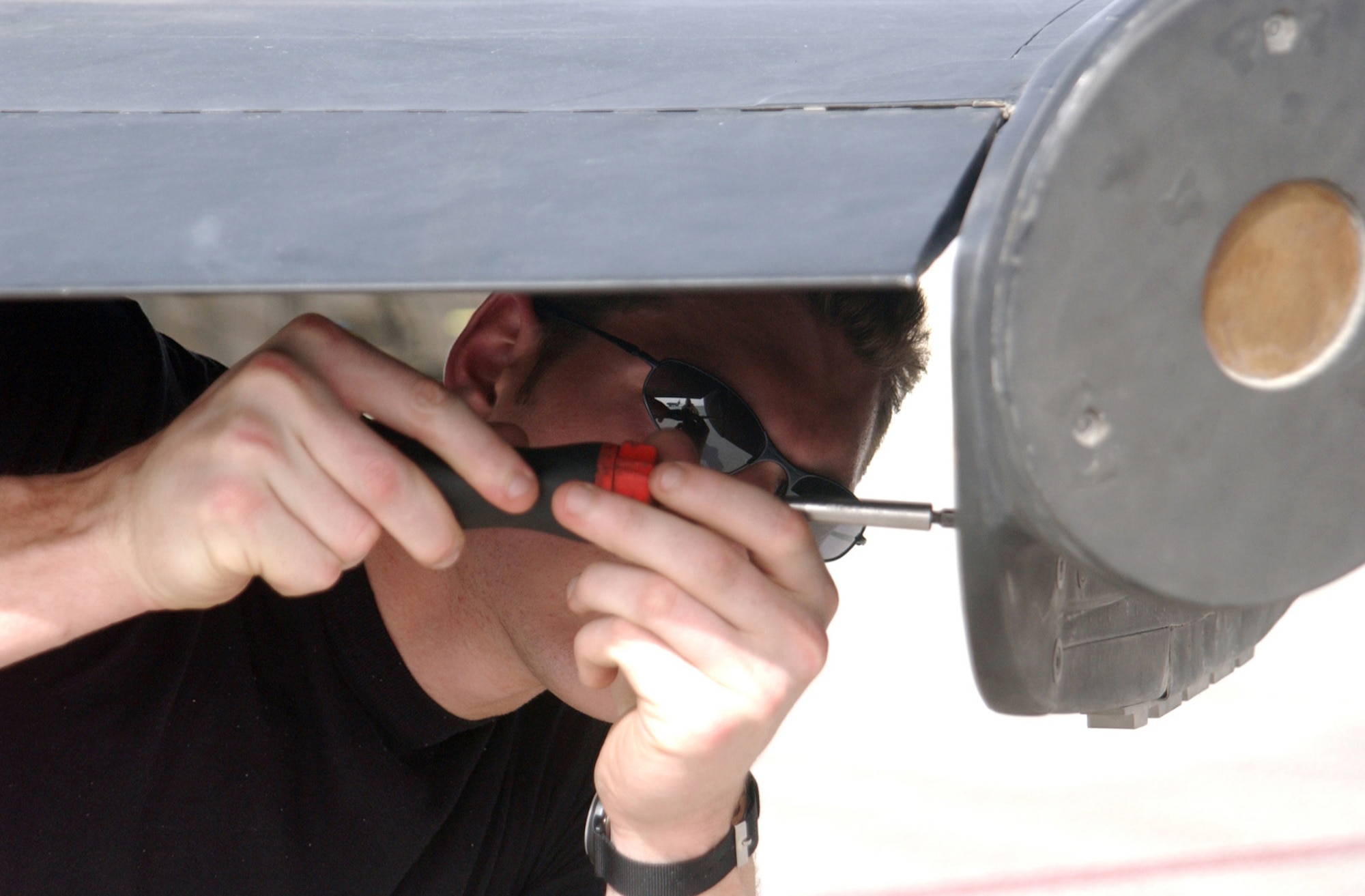 Airman 1st Class Justin Emmett tightens a screw on a U-2 "Dragon Lady." He is with the 99th Aircraft Maintenance Unit, which has a streak of more than 155 consecutive launches without a maintenance-related cancel.  Airman Emmett is deployed from Beale Air Force Base, Calif. (U.S. Air Force photo/Tech. Sgt. Andrew Leonhard)