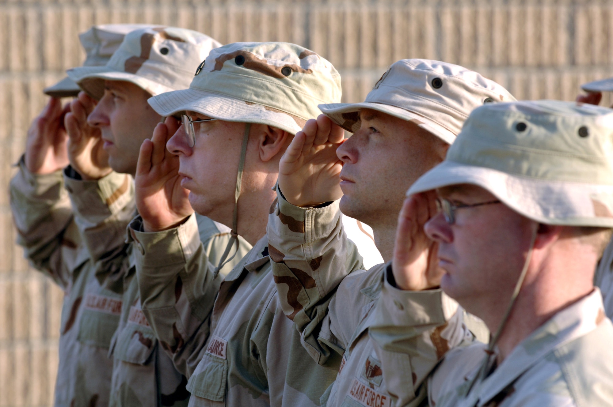 Airmen from the 379th Expeditionary Medical Group salute in formation during a retreat ceremony at a deployed location in Southwest Asia Friday, March 24, 2006. (U.S. Air Force photo/Staff Sgt. Joshua Strang)