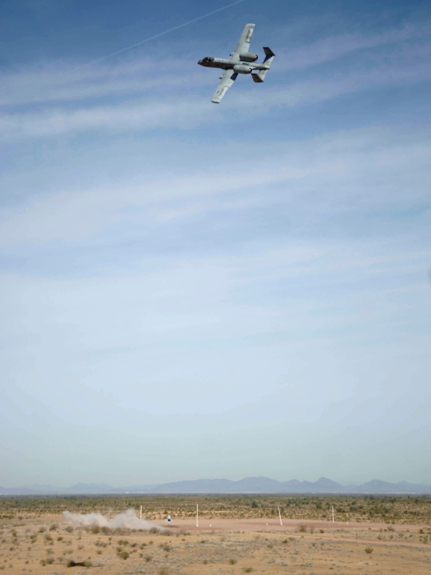 An A-10 Thunderbolt II, flies over the targets after firing its 30mm gun at a low angle strafe, as part of the 2006 Hawgsmoke competition, Thursday, March 23, 2006, at the Barry-Goldwater Range, Gila Bend Air Force Auxiliary Field. There are four parts of the competition, and each team has four members in which they have 100 bullets each to use towards the target. This year's competition coincides with the 30th anniversary of the "Warthog." Twenty squadrons from around the world come together to gain the honor of the "Best of the Best" in ground attack and target destruction. (U.S. Air Force photo/Senior Airman Christina D. Ponte)