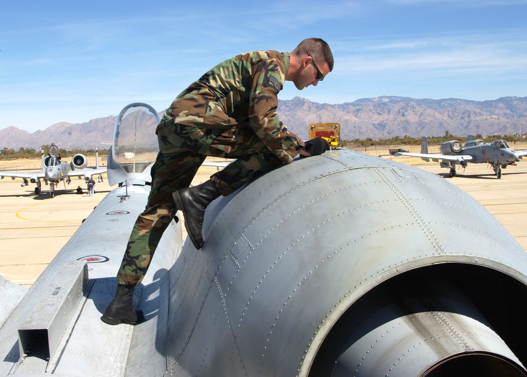 Senior Airman Paul Delgreco maintains the oil of an A-10 Thunderbolt II Thursday, March 23, 2006, during the 2006 Hawgsmoke competition at Davis-Monthan Air Force Base, Ariz.  Hawgsmoke is a biennial worldwide A-10 bombing, missile and tactical gunnery competition. This year's competition coincides with the 30th anniversary of the A-10 rollout in the Air Force inventory. Airman Delgreco is with the 103rd Aircraft Maintenance Squadron in Bradley, Conn. (U.S. Air Force photo/Airman 1st Class Veronica Pierce)