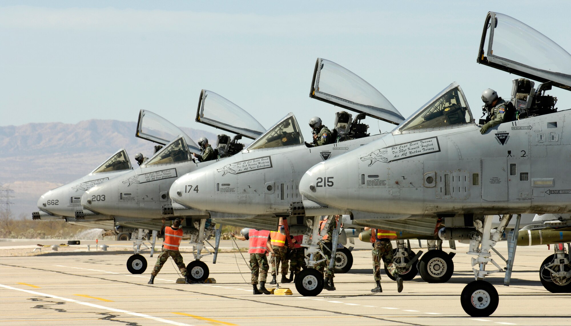 Four A-10 Thunderbolt IIs sit on the end of the runway as maintainers perform pre-flight inspections at Davis-Monthan Air Force Base, Ariz., Thursday, March 23, 2006, as part of the 2006 Hawgsmoke competition. This year marks the 30th anniversary of the "Warthog." Hawgsmoke is a biennial bombing and tactical gunnery competition of the A-10, in which 20 squadrons around the globe come together to fly the Warthog and compete for the honor of the "best of the best" in ground attack and target destruction. (U.S. Air Force photo/Airman 1st Class Jesse Shipps)