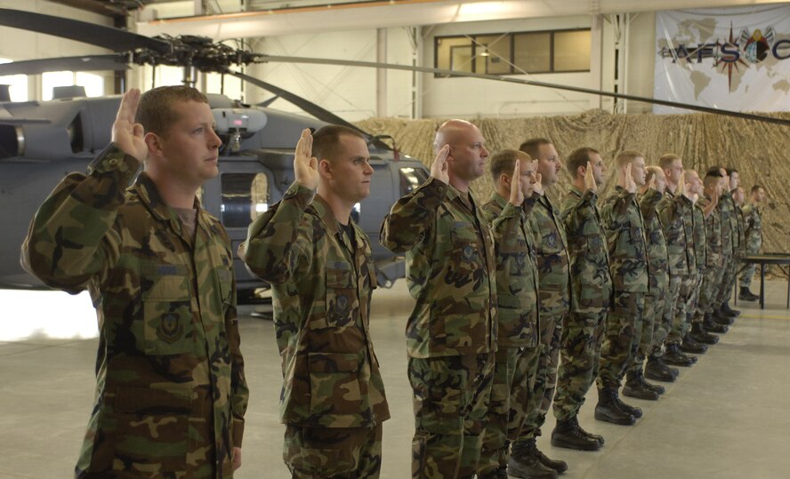 MOODY AIR FORCE BASE, Ga. - Airmen from the 347th Aircraft Maintenance Squadron recite a crew chief oath during the Dedicated Crew Chief Ceremony March 24 here. The ceremony dedicated one Airman to manage the overall maintenance of each of Moody's HC-130P/N and HH-60G Pave Hawks.  (Photo by Staff Sgt. Manuel Martinez)