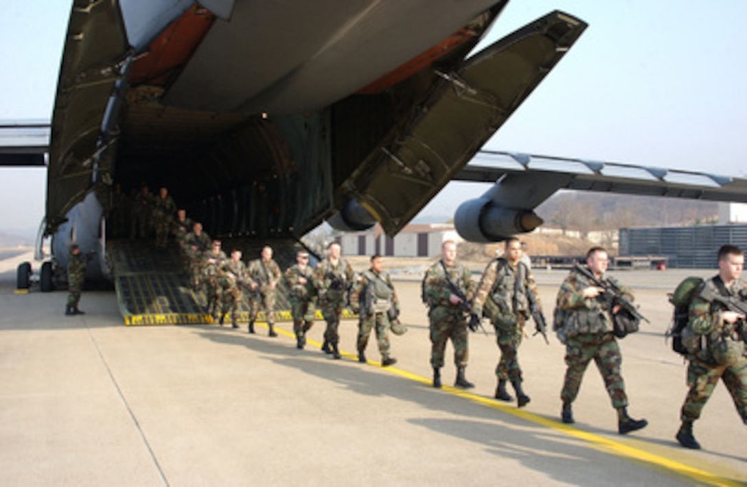 U.S. Army soldiers file out from a U.S. Air Force C-5 Galaxy aircraft at Daegu Air Base, South Korea, for Reception, Staging, Onward Movement and Integration training exercise Foal Eagle on March 25, 2006. Foal Eagle is a joint exercise between the Republic of Korea and the U.S. Armed Forces designed to enhance war-fighting skills. The soldiers are assigned to Kilo Troop, 3rd Squadron, 2nd Armored Cavalry Regiment, deployed from Fort Lewis, Wash. 