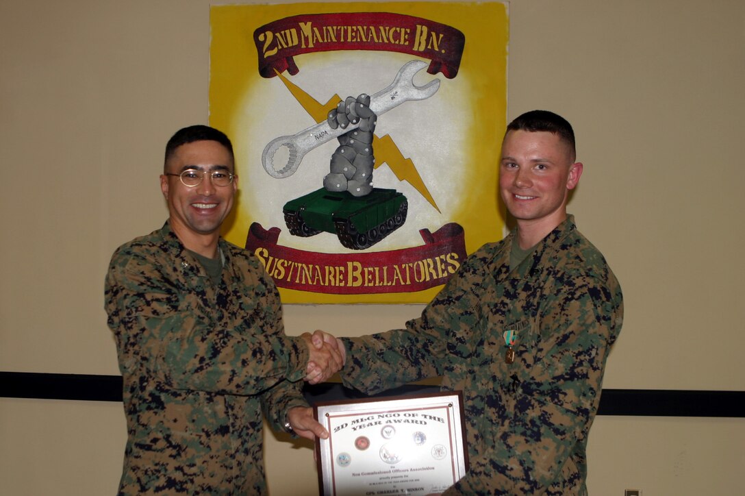 MARINE CORPS BASE CAMP LEJEUNE, N.C. (March 28, 2006) ? Lieutenant Col. Bruce E. Nickel presents a certificate to Cpl. Charles T. Hinson here March 28. Hinson was awarded Non-Commissioned Officer of the Year for 2nd Marine Logistics Group and 2nd Maintenance Battalion along with the Navy and Marine Corps Achievement Medal for his outstanding service and leadership during two combat deployments to Iraq. Nickle is the commanding officer for 2nd Maintenance Bn. and Hinson is the missile/tank repair section head for Ordnance Maintenance Company, 2nd Maintenance Bn., 2nd MLG. (Official U.S. Marine Corps Photo by Lance Cpl. Wayne Edmiston)(Released)