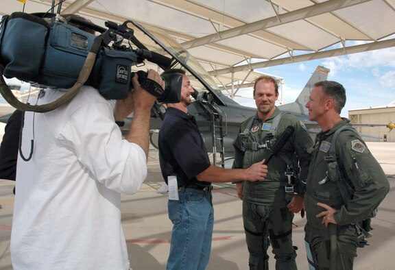 Members of the Dallas/Fort Worth media interview Texas Rangers pitcher Kevin Millwood and Col. William Binger, 944th Operations Group commander, following Mr. Millwood's orientation F-16 flight March 28. (U.S. Air Force Reserve photo by Staff Sgt. Susan Stout)