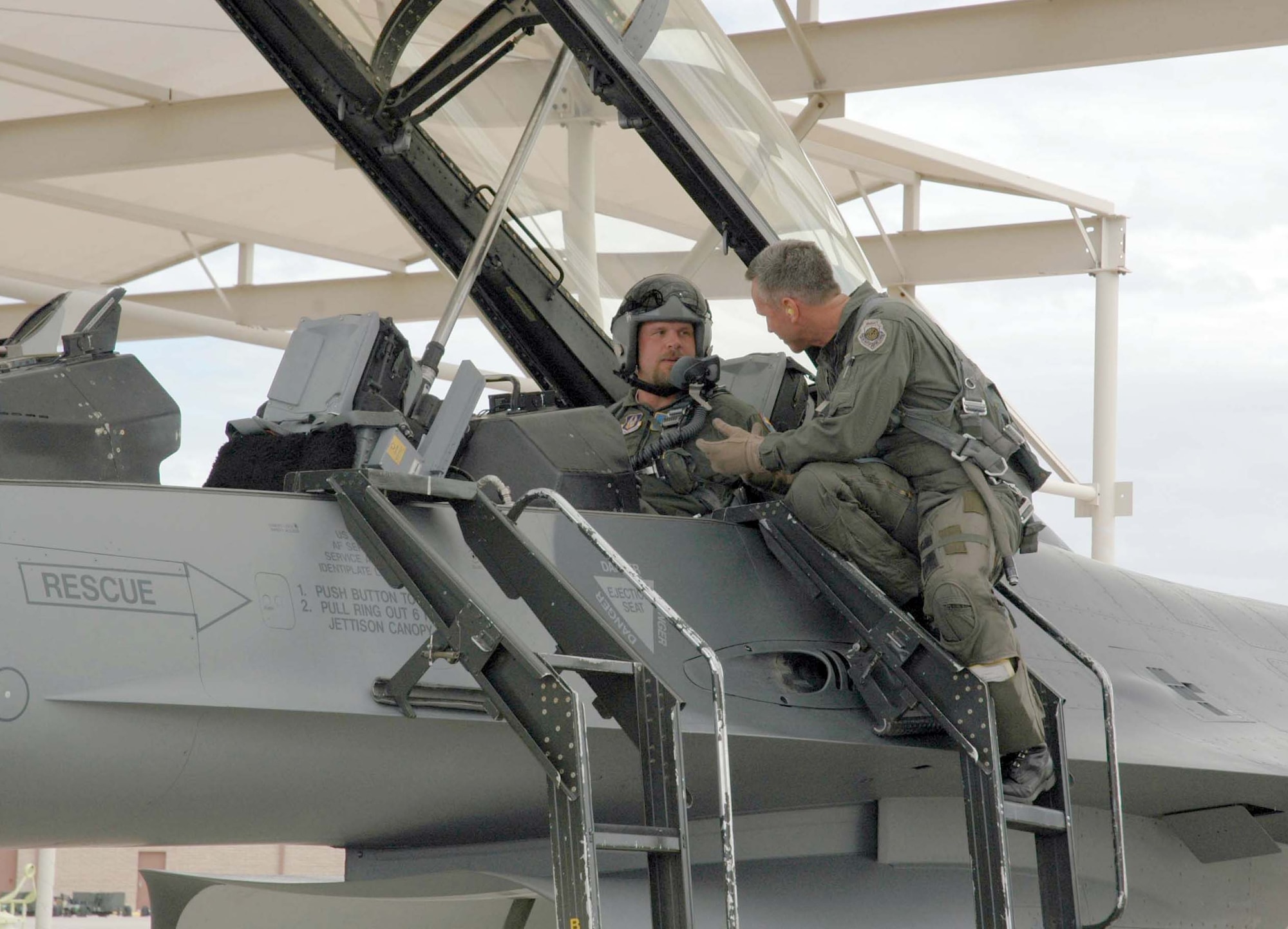 Col. William Binger, 944th Operations Group commander, goes over the F-16 with Kevin Millwood, Texas Rangers pitcher, before their flight March 28. Mr. Millwood, a strong supporter of the U.S. Air Force mission, is currently participating in spring training at the Surprise Stadium, located near Luke Air Force Base, Ariz. (U.S. Air Force Reserve photo by Staff Sgt. Susan Stout)
