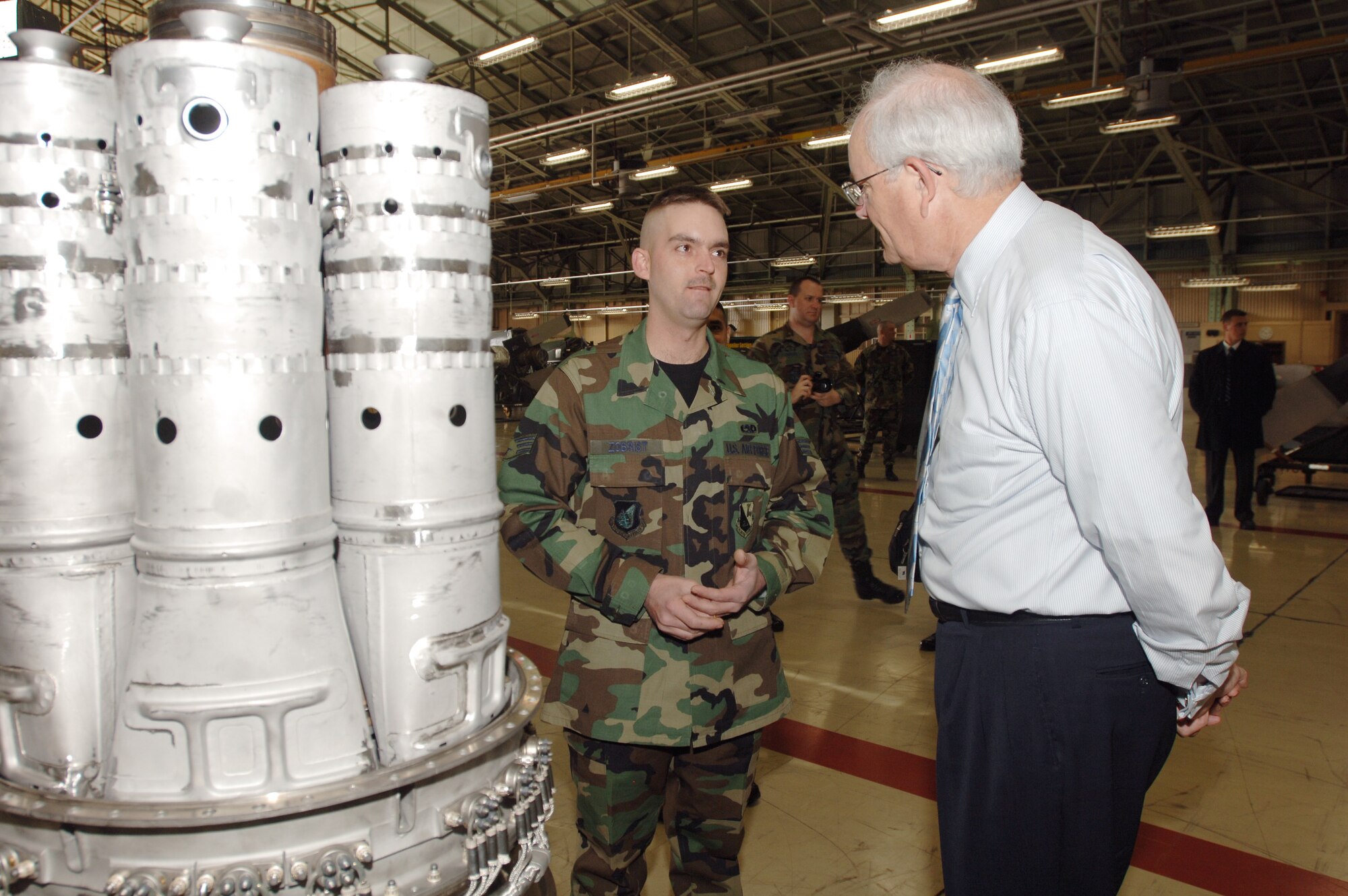 Secretary of the Air Force Michael W. Wynne receives a briefing from Senior Airman Daryl Zobrist on his job at the C-130 Hercules Engine Shop, 374th Maintenance Squadron, Yokota Air Base, Japan, on Friday, March 24, 2006.   (U.S. Air Force photo/Yasuo Osakabe)
