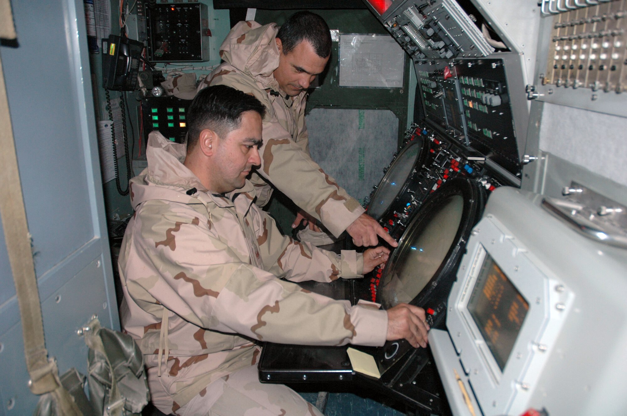 Staff Sgts. Luis Nazario and Jose Saavedra ensure radar is working properly at Kirkuk Air Base, Iraq. The Airmen perform maintenance checks on the unmanned radar twice daily.  (U.S. Air Force photo/Staff Sgt. Kristina Barrett)